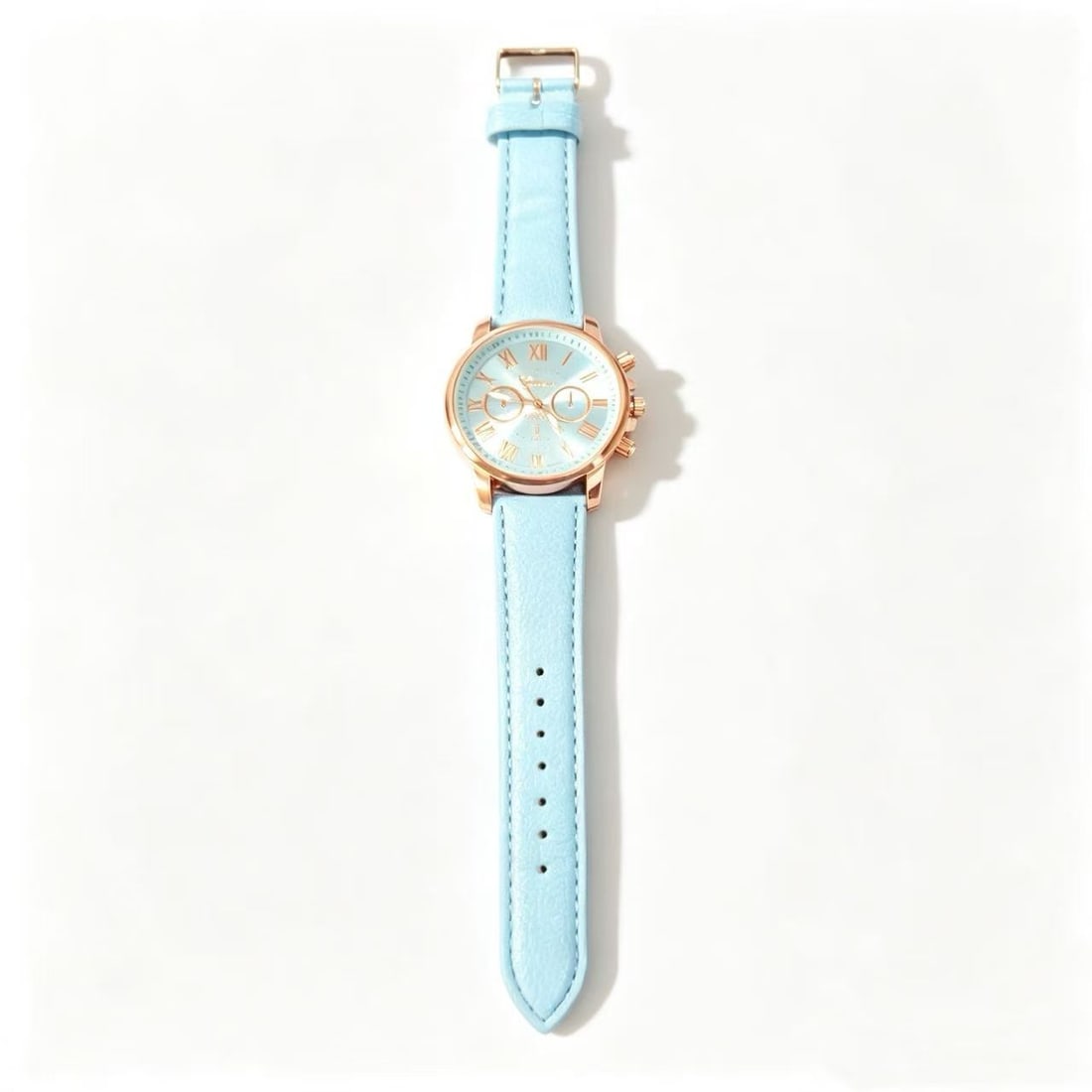 Gold-Gilded Light Blue Strap Wristwatch: Decorative wristwatch featuring a light blue strap, gold-gilded case accents, Roman numeral markers, and contemporary minimalist styling.