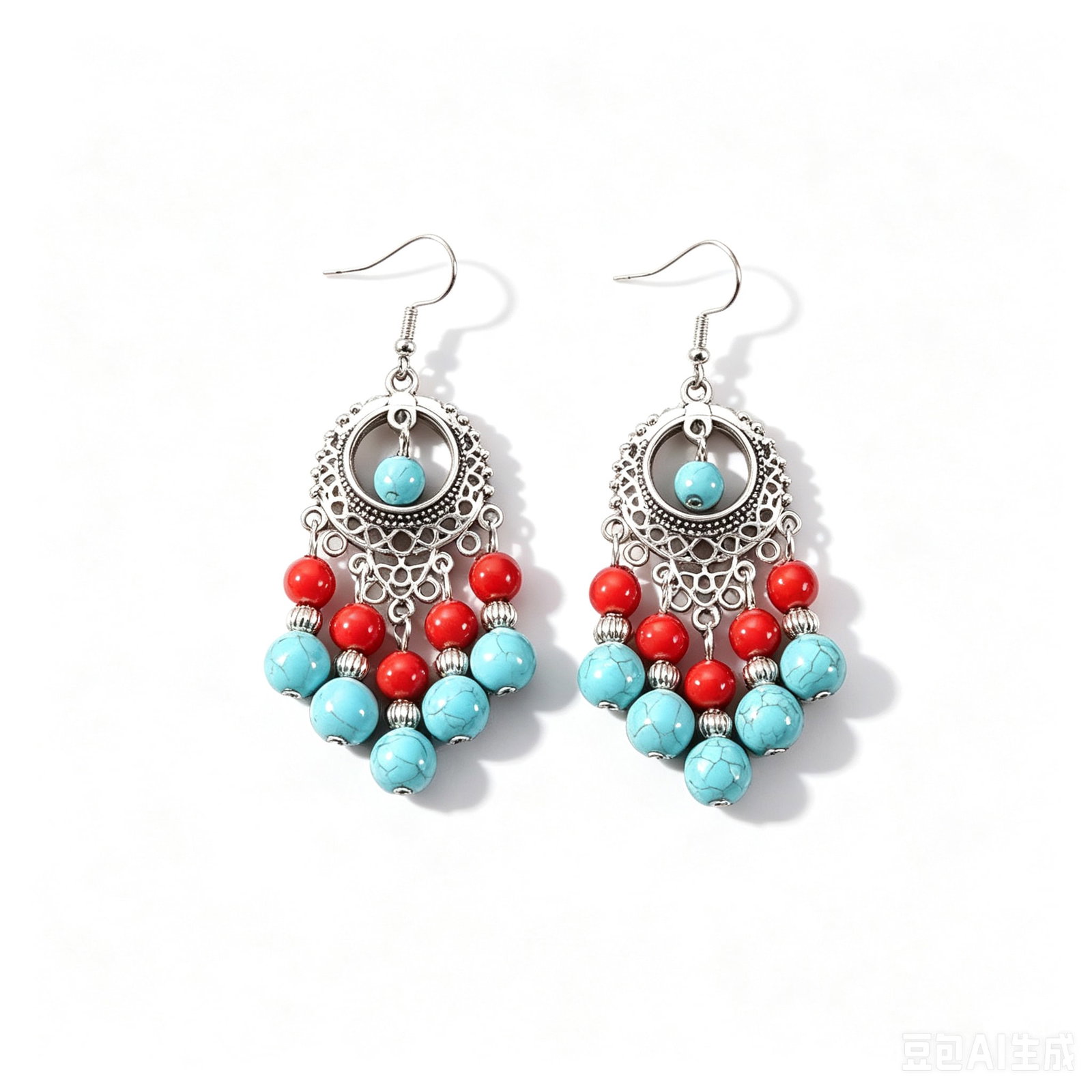 Turquoise & Silver Tone Chandelier Drop Earrings: Pair of chandelier-style drop earrings featuring turquoise-style bead accents combined with silver-tone openwork metal detailing and red bead embellishments. Designed with layered hanging elements in