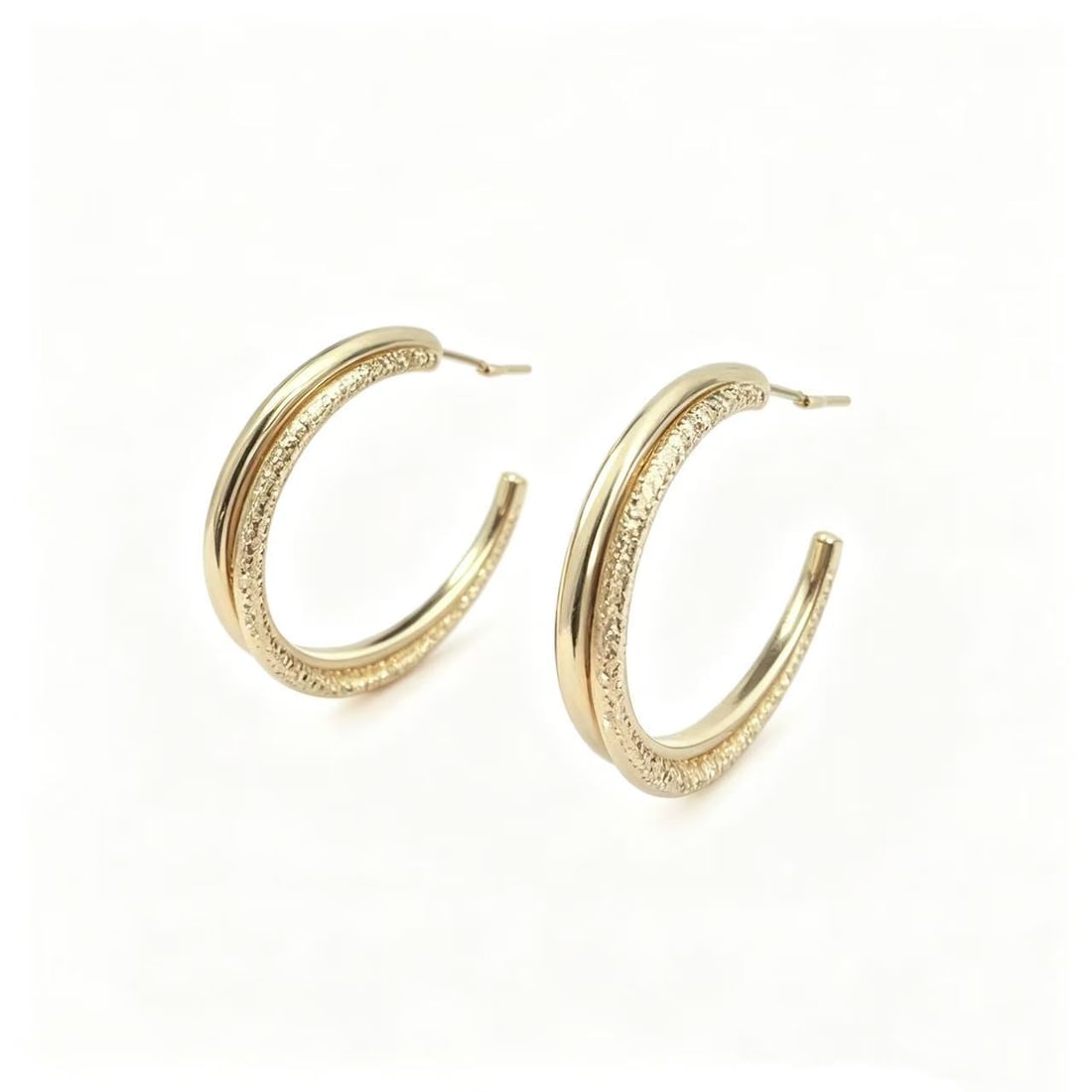 Gold-Gilded Textured Hoop Earrings: Pair of contemporary hoop earrings featuring a rounded open hoop design with polished and textured gold-gilded surfaces. Minimalist style suitable for everyday wear and modern jewelry collections.