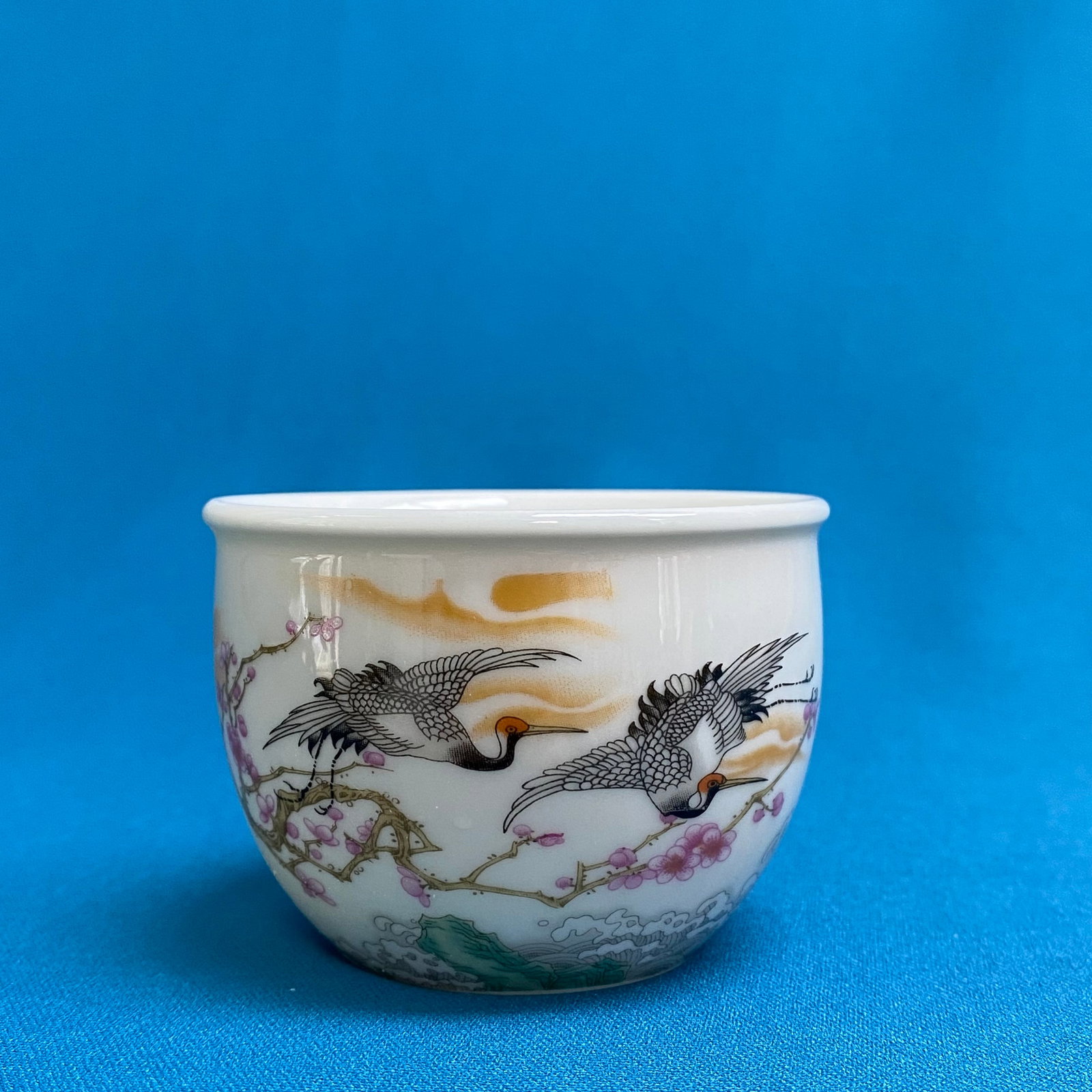 Chinese Famille Rose 'Cranes and Pine' Porcelain Miniature Planter / Incense Burner: This miniature porcelain vessel features a deep, rounded body with a slightly flared rim. The exterior is finely decorated in the traditional Famille Rose palette, depicting red-crowned cranes in flig