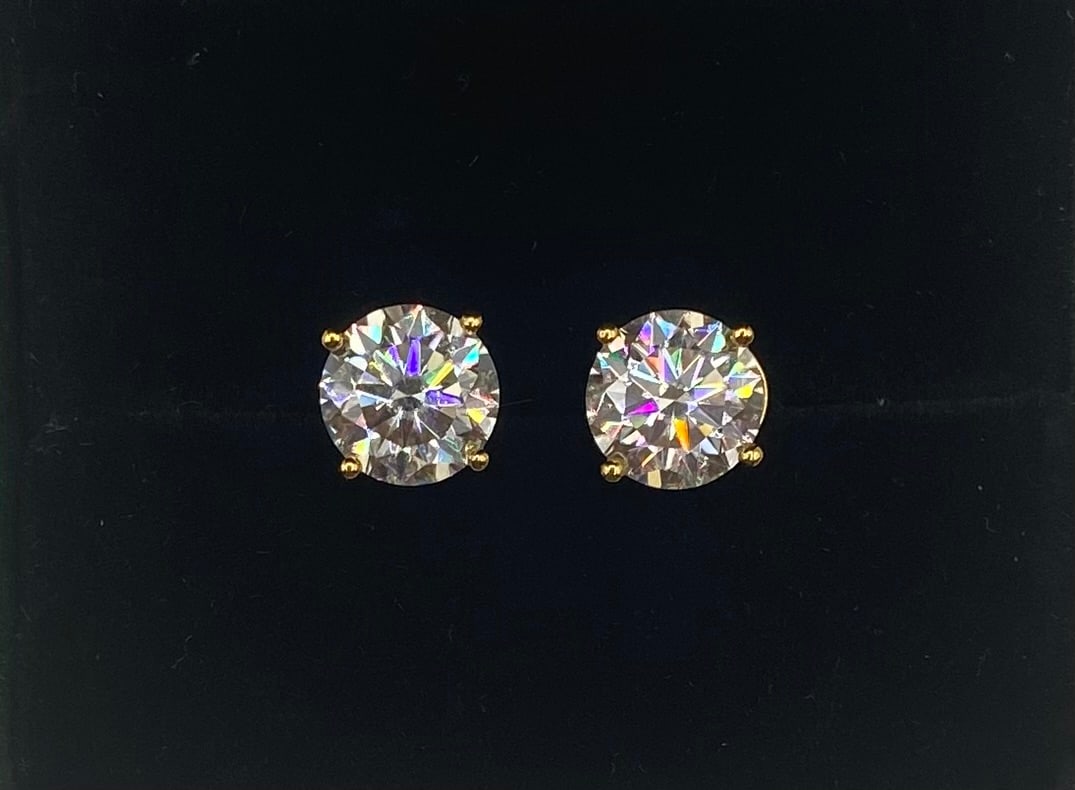 6 CTW D VVS1 Moissanite Stud Earrings | 18K Yellow Gold Plated 925 Silver: A classic essential, these sparkling round moissanite stud earrings deliver extraordinary clarity and fire. Set in a traditional 4-prong basket of 18K yellow gold plated over solid 925 sterling silver