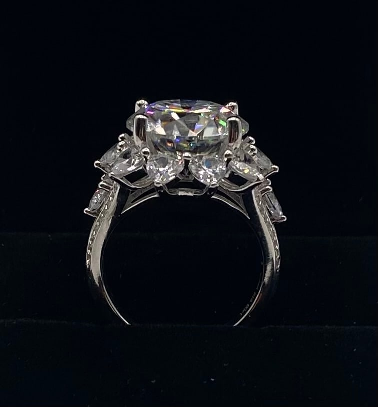 Statement Moissanite Cluster Halo Ring | 18K White Gold Plated 925 Silver: Designed for dramatic presence, this showstopping ring features a large round central moissanite bordered by fancy-shaped moissanite halo accents and a pavé band. Plated in brilliant 18K white gold o