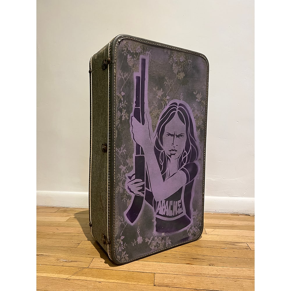 Douglas Miles, Forced Removal Series: Shotgun Gas Can - suitcase only: Douglas Miles, a Native American artist from the San Carlos Apache Tribe in the United States, is an artist, photographer, curator, writer, muralist, public speaker, and film director. While Miles