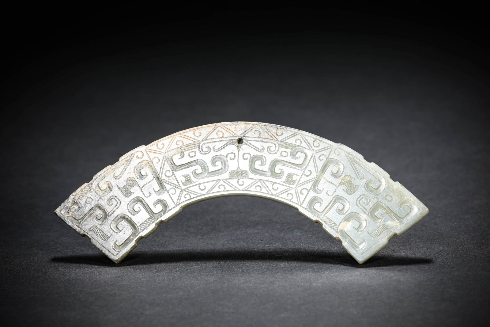 A JADE 'HUANG' PENDANT: A JADE 'HUANG' PENDANT Dimensions: Width: 13.1 cm (5.2 in.), Height: 3 cm (1.2 in.). All measurements are approximate.