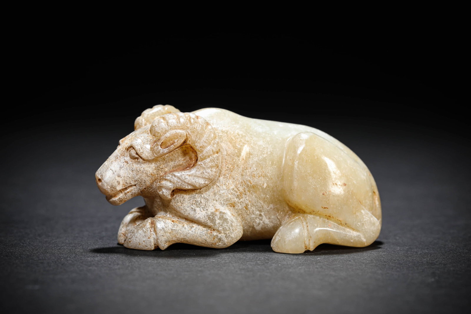 A JADE 'AUSPICIOUS BEAST' ORNAMENT: A JADE 'AUSPICIOUS BEAST' ORNAMENT Dimensions: Length: 7.7 cm (3.0 in.), Width: 3.8 cm (1.5 in.), Height: 3.6 cm (1.4 in.). All measurements are approximate.