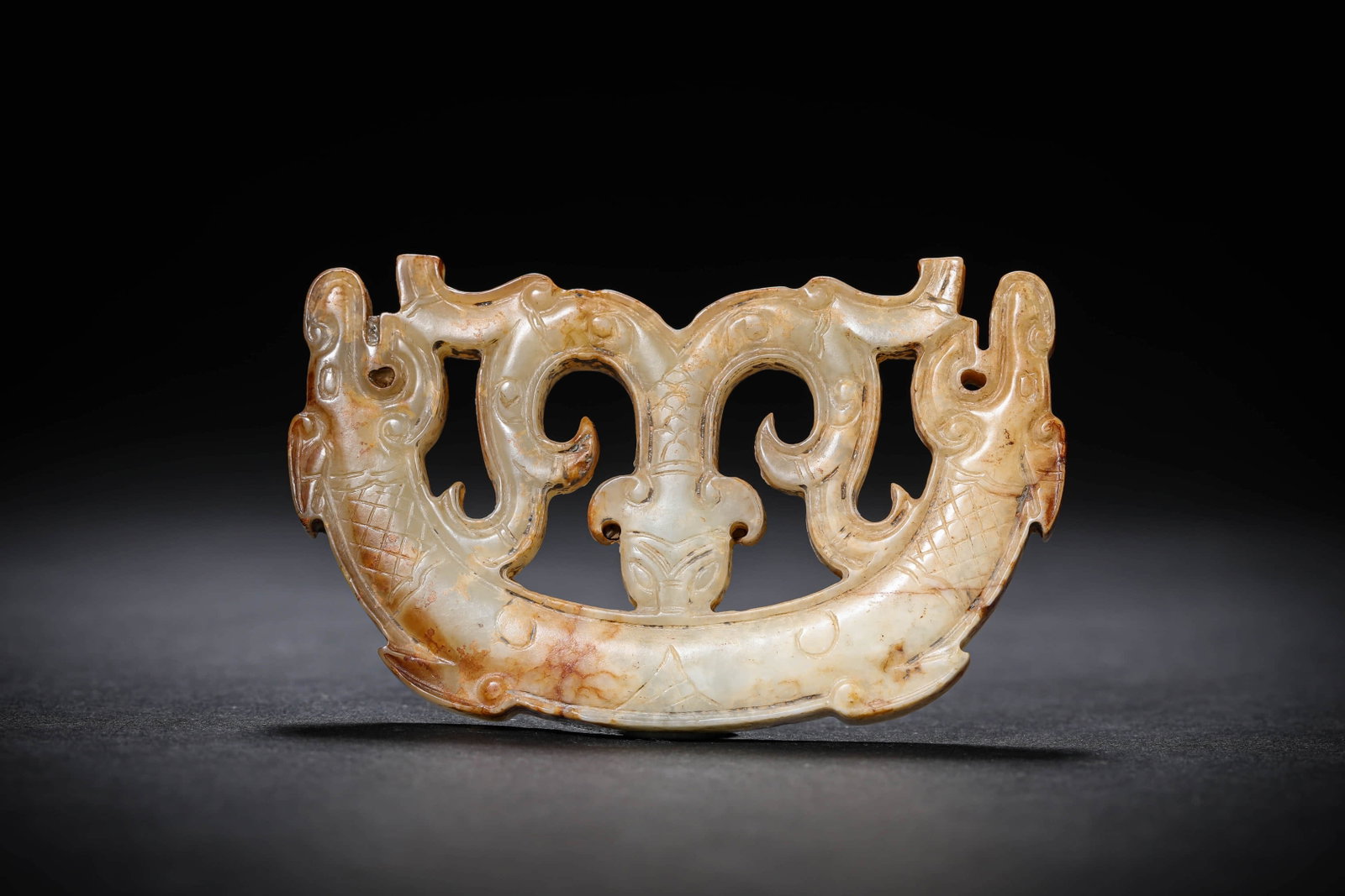 A JADE 'DOUBLE DRAGON' HENG: A JADE 'DOUBLE DRAGON' HENG Dimensions: Width: 7 cm (2.8 in.), Height: 4.2 cm (1.7 in.). All measurements are approximate.