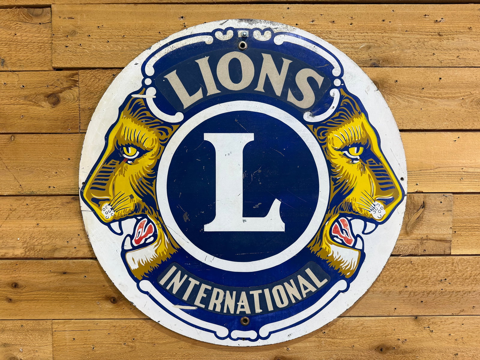 Single sided painted metal International Lions Sign: Single-Sided Painted Metal International Lions Sign. A classic fraternal advertising piece with strong color and visual appeal. In good overall condition, showing minor wear and scratching across the 