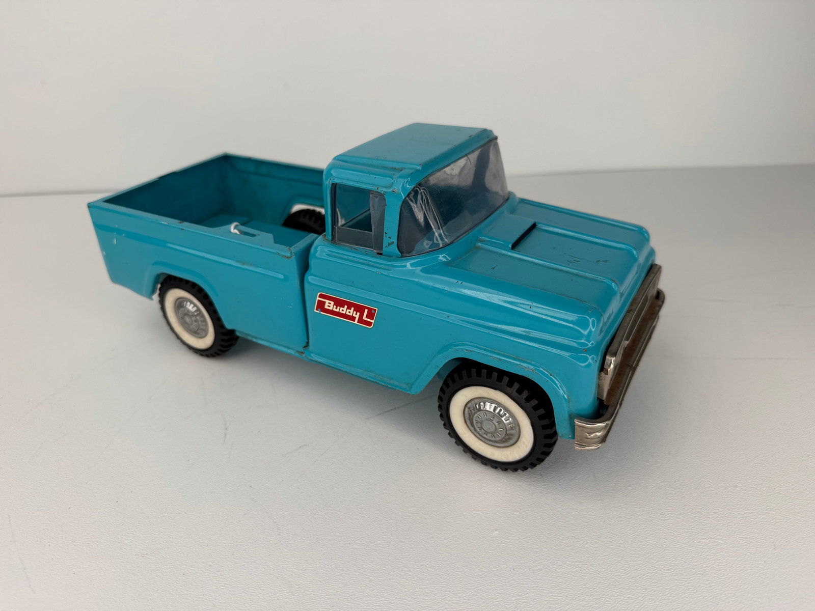 1960s Buddy L dog kennel toy pickup truck: 1960s Buddy L Dog Kennel Pickup Truck featuring a clean original finish with great vintage appeal. Missing several pieces, including the kennel sections, but remains an attractive and desirable collec