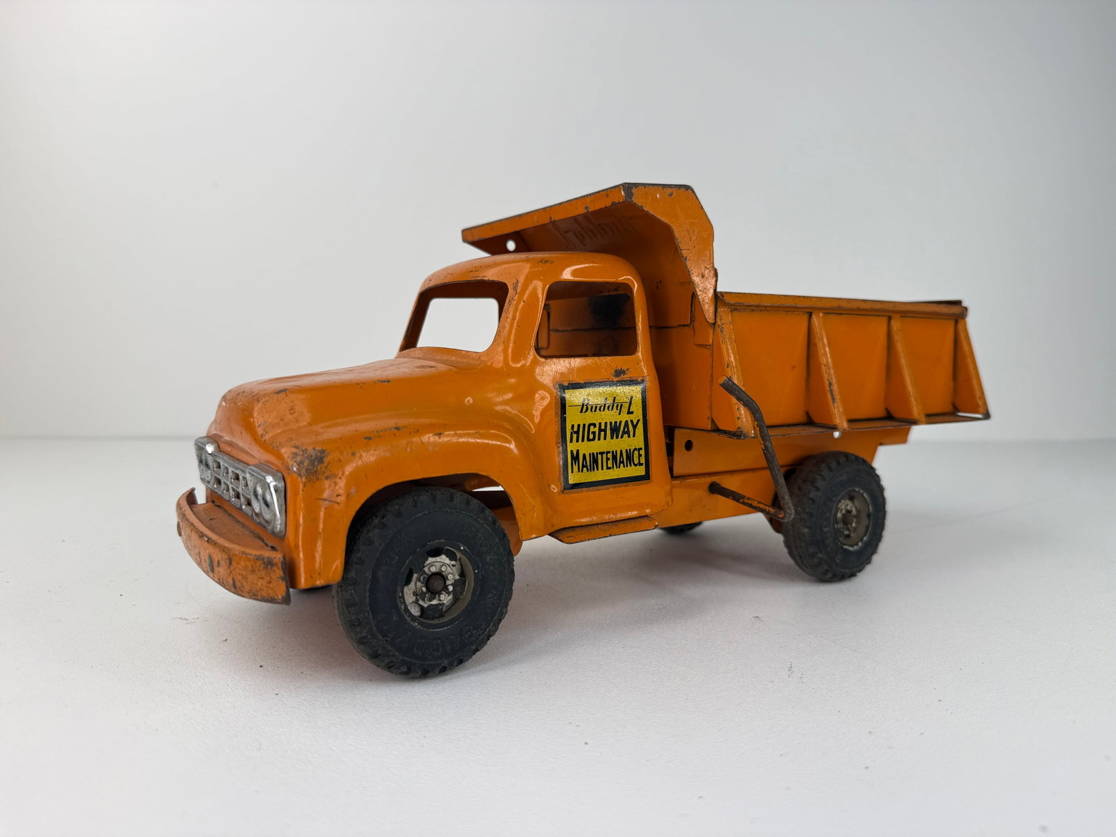Pressed Steel Buddy L Highway Dump Truck: Painted Pressed Steel Buddy L Highway Maintenance Truck in good overall condition. Exhibits moderate rust, paint wear, and age-related use while retaining excellent vintage character. A desirable Budd