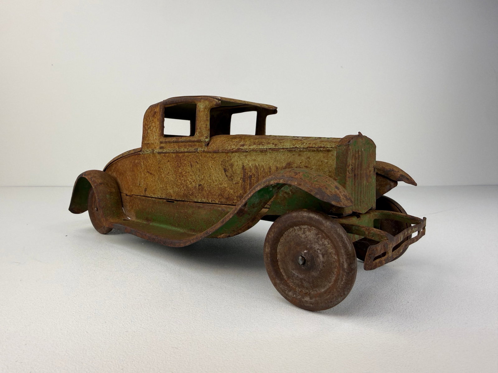 1930s Kingsbury Pressed Steel Car: Kingsbury Pressed Steel Car in original condition, showing scratches, paint chips, and wear consistent with age and use. The front wheels turn freely, adding to its vintage functionality. A desirable 