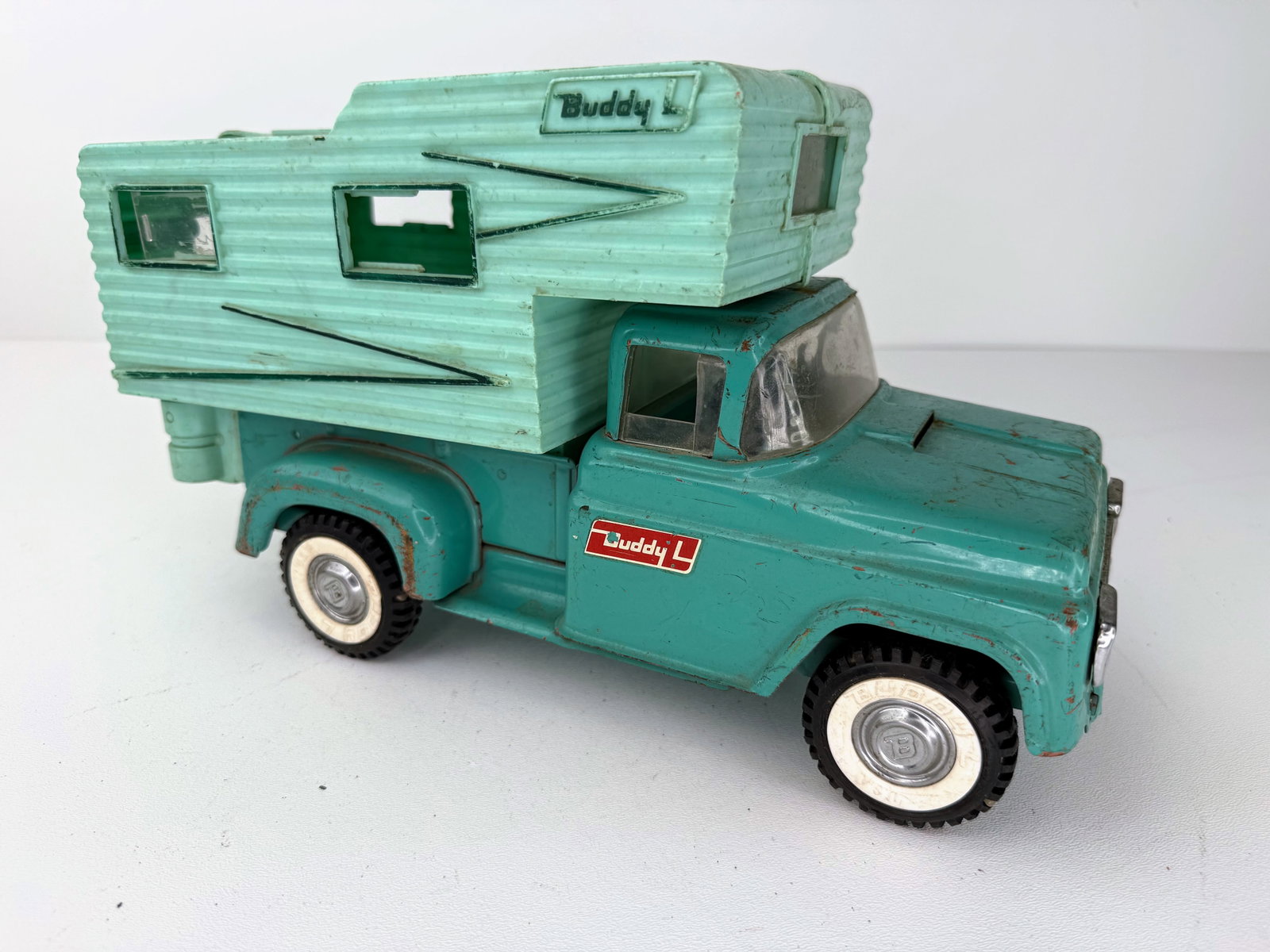 Buddy L Pressed Steel No. 5433 Campers Truck: Early 1960s Buddy L No. 5433 Pressed Steel Camper Truck featuring its original camper top and spring-loaded front suspension, which remains in good working order. The truck shows fender rubs, scratche