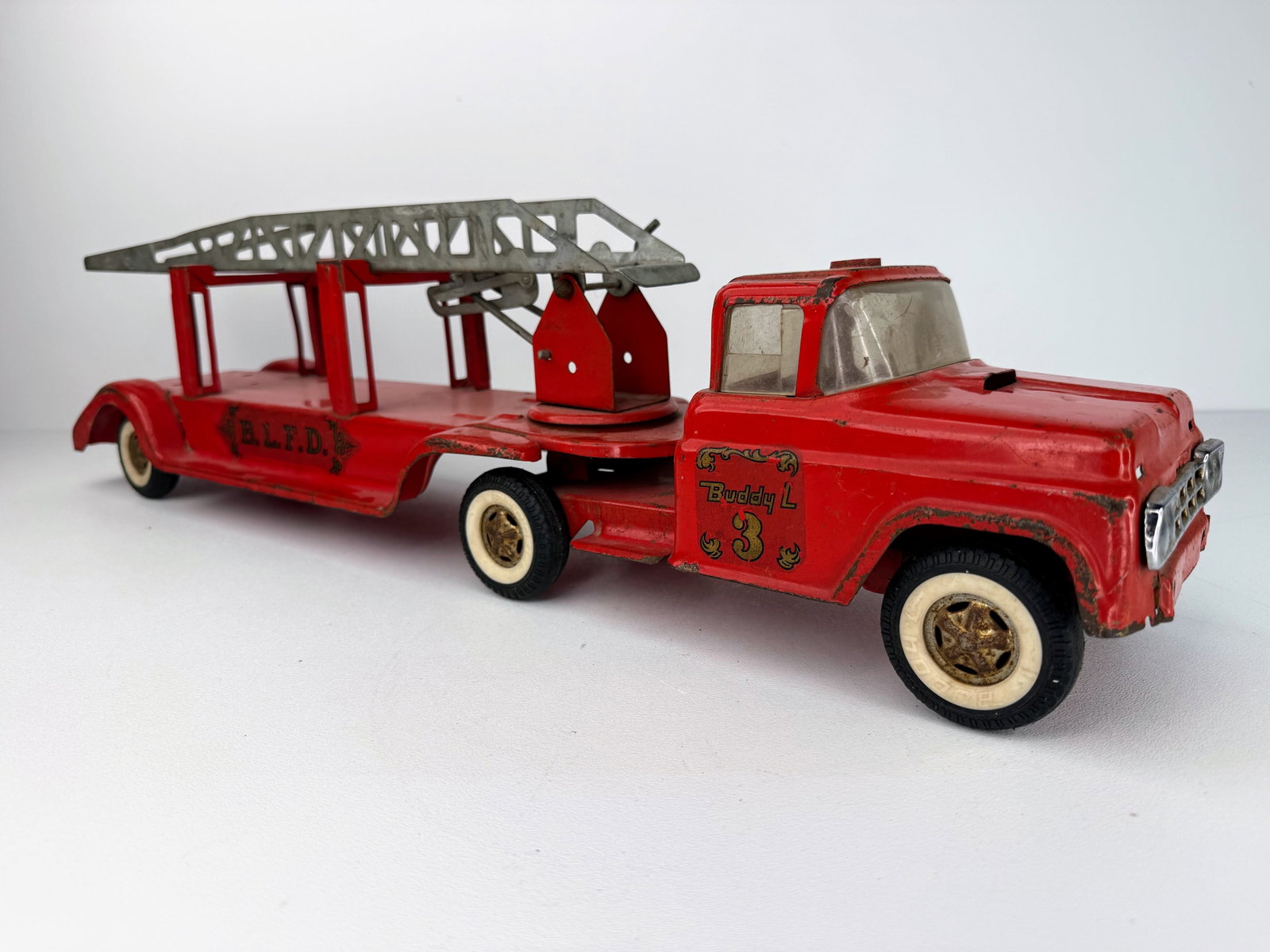Buddy L 1950s Ladder Fire Truck: Buddy L 1950s ladder fire truck. A great vintage fire truck in good overall condition featuring its original paint. The ladder still raises and lowers as intended, making this an excellent addition to