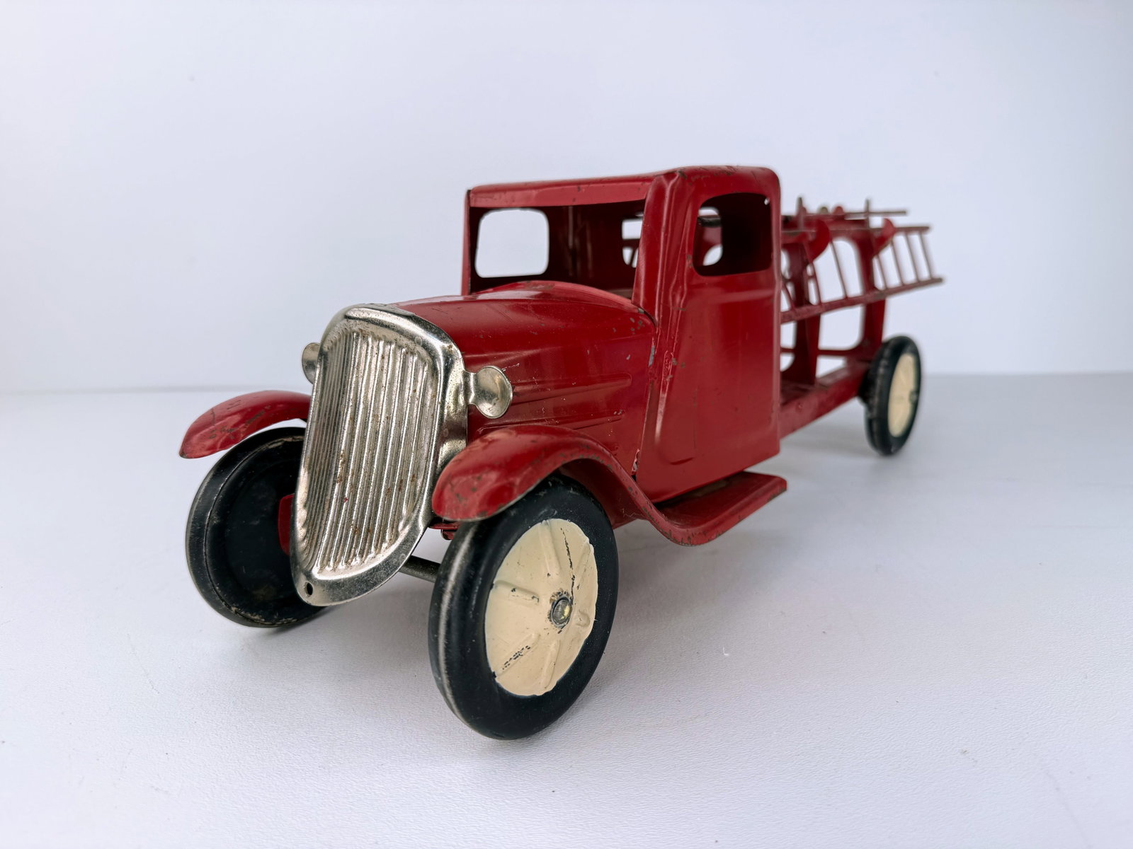 Turner Toys Pressed Metal Mack Hook and Ladder Fire Truck: Turner Toys pressed metal Mack Hook and Ladder fire truck. A great early pressed steel fire truck featuring three original ladders. An excellent addition to any vintage toy or fire memorabilia collect