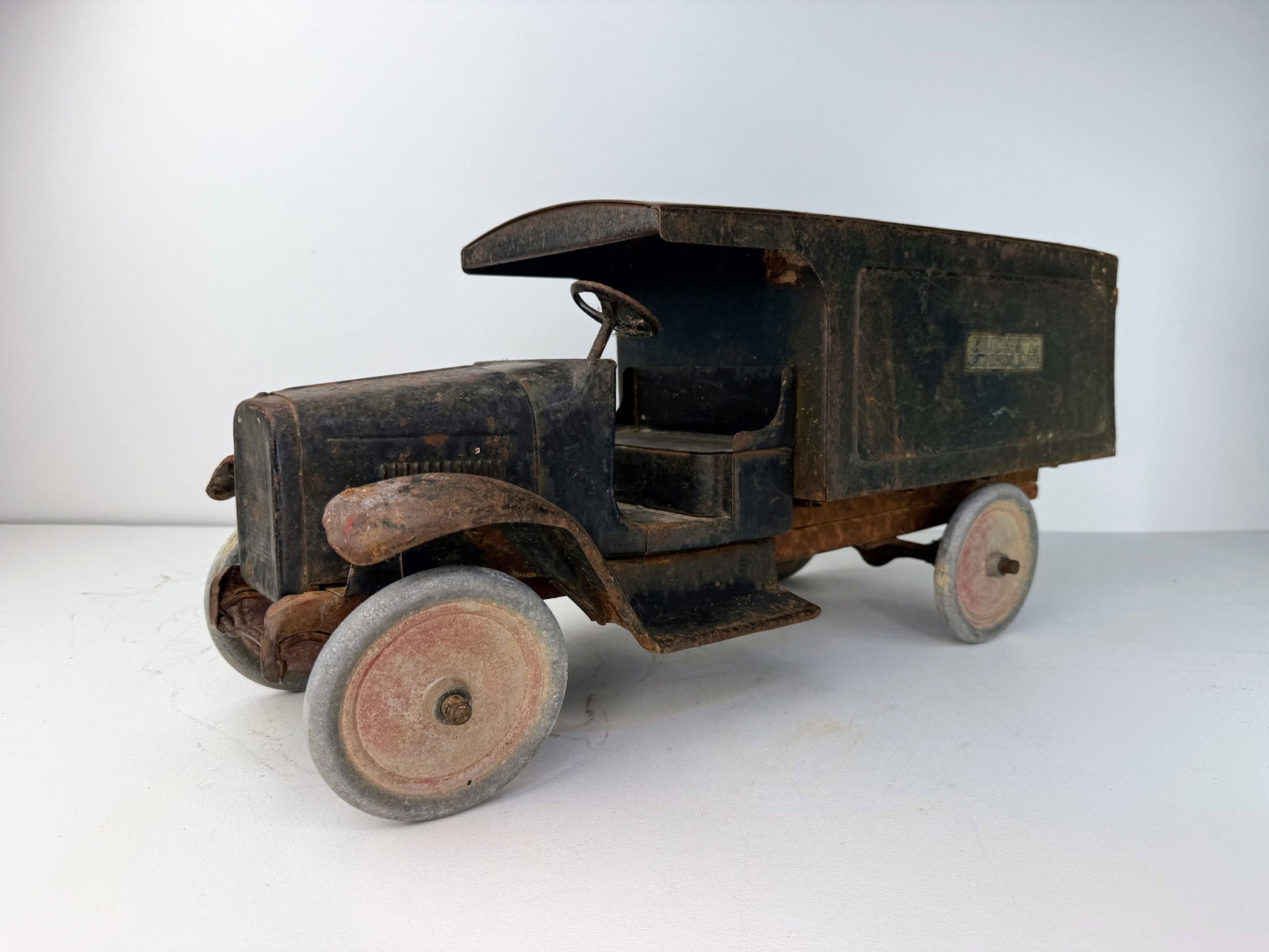 1920s Buddy L "Express Line" pressed steel delivery truck: Heavy-duty pressed steel truck. Constructed of durable pressed steel, this vintage truck shows an attractive aged patina with rusting consistent with its age. Despite the wear, it remains in good over