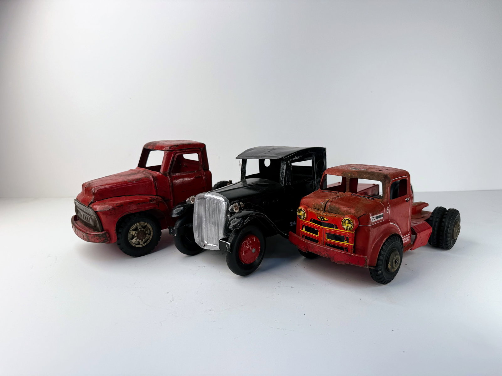 Lot of three Trucks: Lot of three vintage trucks including examples by Structo and Buddy L. The trucks show heavy wear and are in rough condition but make great additions to a vintage toy collection or restoration project