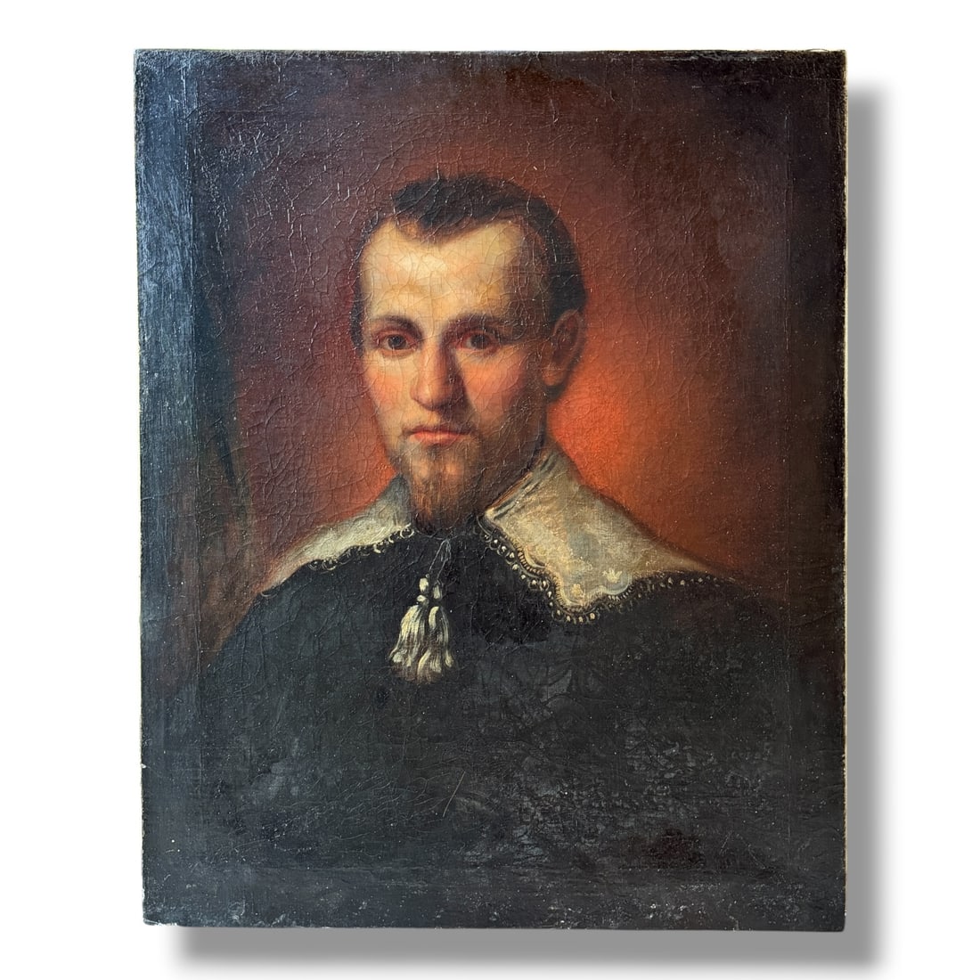 Antique Oil on Canvas Portrait Painting Of Bearded Man: This is an antique oilon canvas painting, likely 19th century, depicting the portrait of a bearded man. This painting appears to have been possibly over painted and relined, and shows significant craq