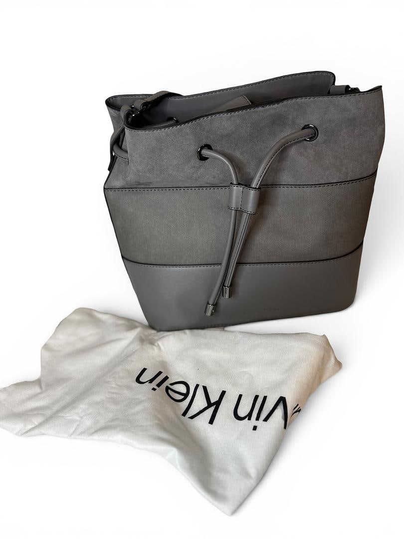 Calvin Klein fki Grey and White GABRIANNA Bucket Shoulder Bag Suede Leather Stone Dust Bag and Care: LOT 90 Calvin Klein; Style# H2DJG9HT fki Grey/White GABRIANNA Bucket Shoulder Bag Suede Leather Stone NWOT MSRP $148.00 UPC 196284471640; Included: Dust Bag, Care Card