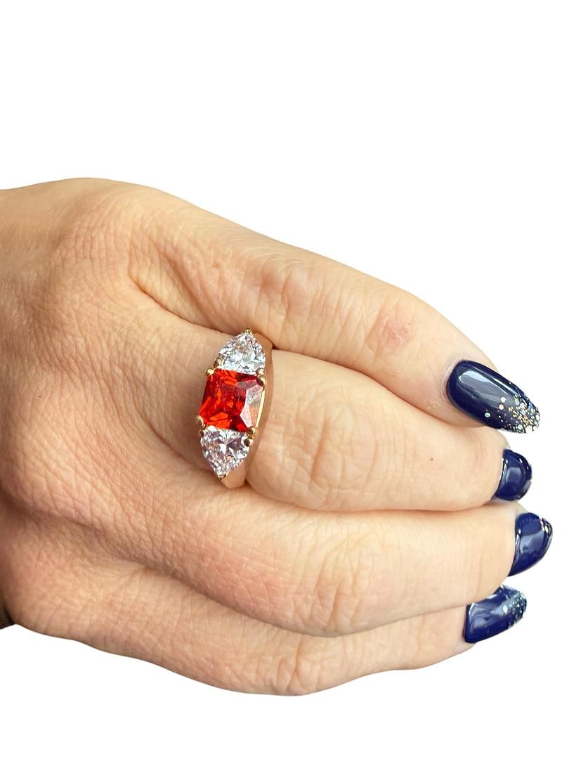 Sterling Silver Womens Statement Ring with 14KT GP Fire Orange Gemstone Cushioned Princess Center: LOT 125 Sterling Silver Womens Statement Ring with 14KT GP Fire Orange Gemstone Cushioned Princess Center Stone with 2 Heart Shaped CZ Diamond Accent Stones Size 9 total weight 8 grams