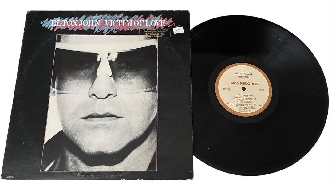 PROMO Elton John Victim Of Love LP Vinyl Record: PROMO LOT 137ARTIST: Elton John TITLE: Victim of Love RELEASED: 1979 CATALOG #: MCA-5104 Vinyl 12" GENRE: Rock TRACK LIST:A1. Johnny B. Goode (8:06)A2. Warm Love In A Cold World (3:22)A3. Born Bad
