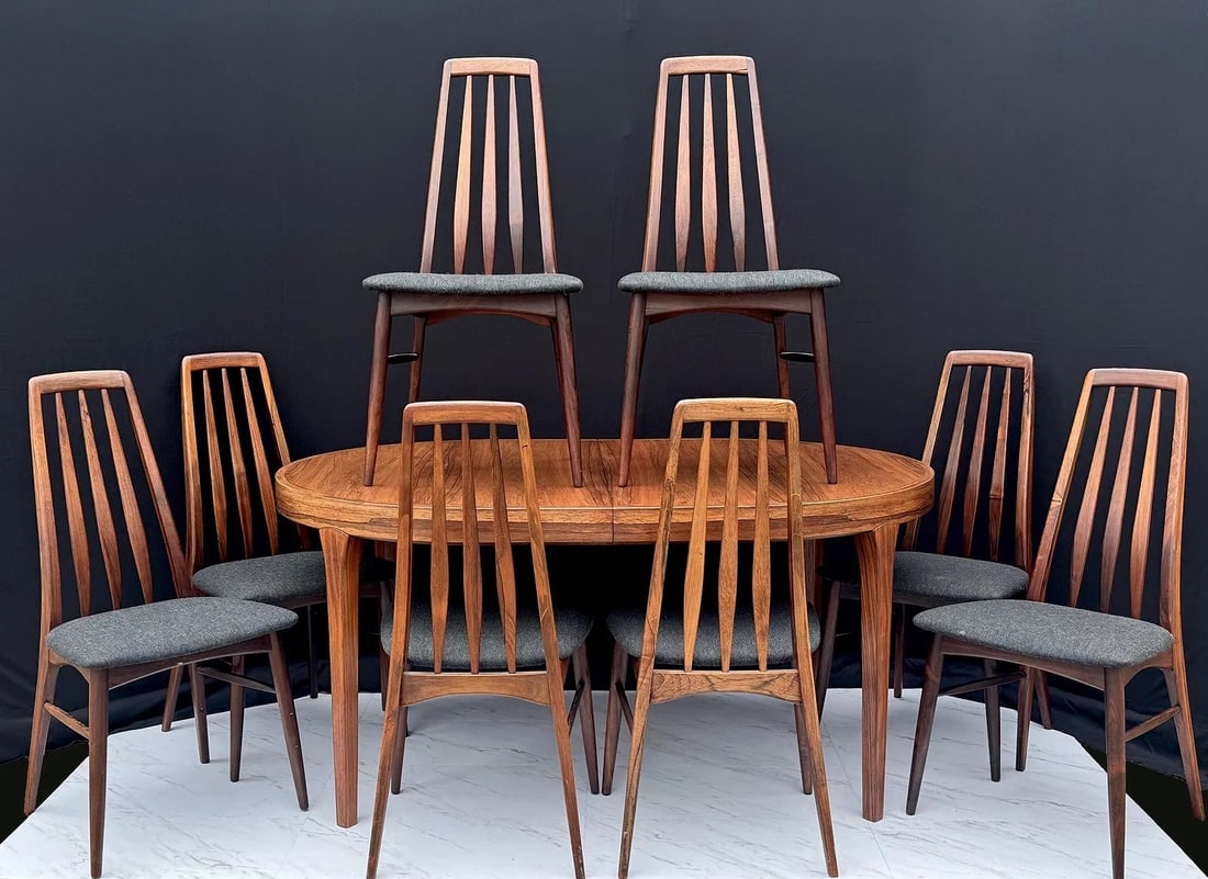 Niels Koefoed Mid-Century Danish Teak Extendable Dining Set: Danish extendable teak dining table with eight “Eva” chairs designed by Niels Koefoed for Koefoeds Hornslet. Table and chairs are stamped on the underside. Set includes two leaves and protecti