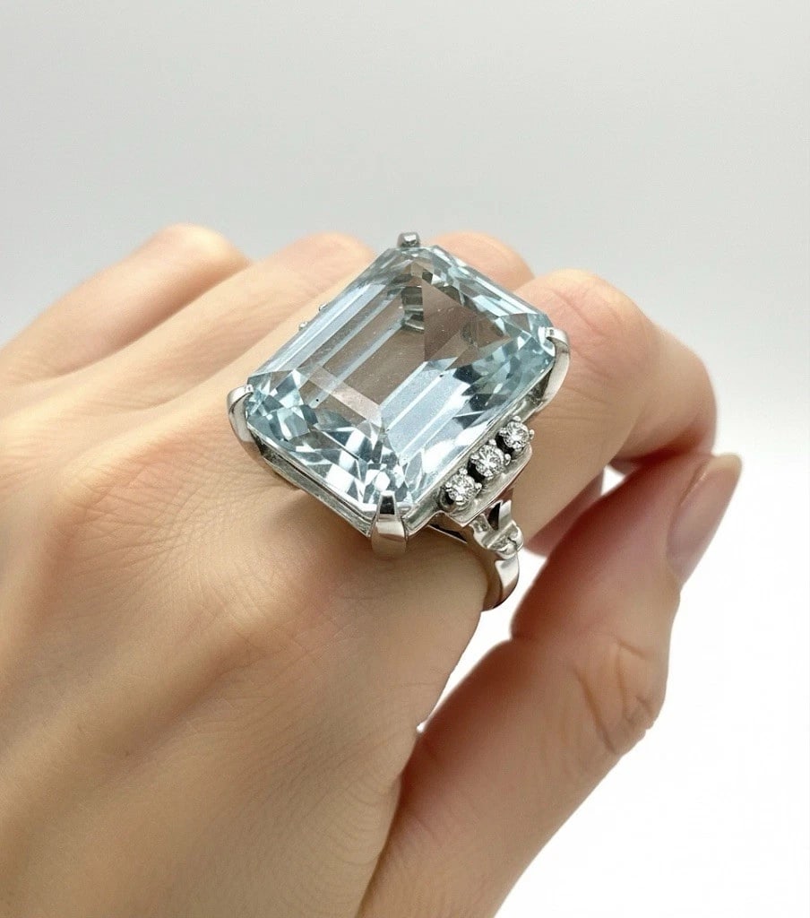 GIA Cert. Estate 1930s Retro 27 Carats Emerald Cut Aquamarine Cocktail Ring 14K: Condition: Excellent, Gently pre owned Era: Late Art Deco - Early Retro Metal: 14k White Gold Gemstone: Aquamarine Species: Natural Beryl Carat Weight: Approx. 27 carats Measurements: 20.49 x 16.11 x