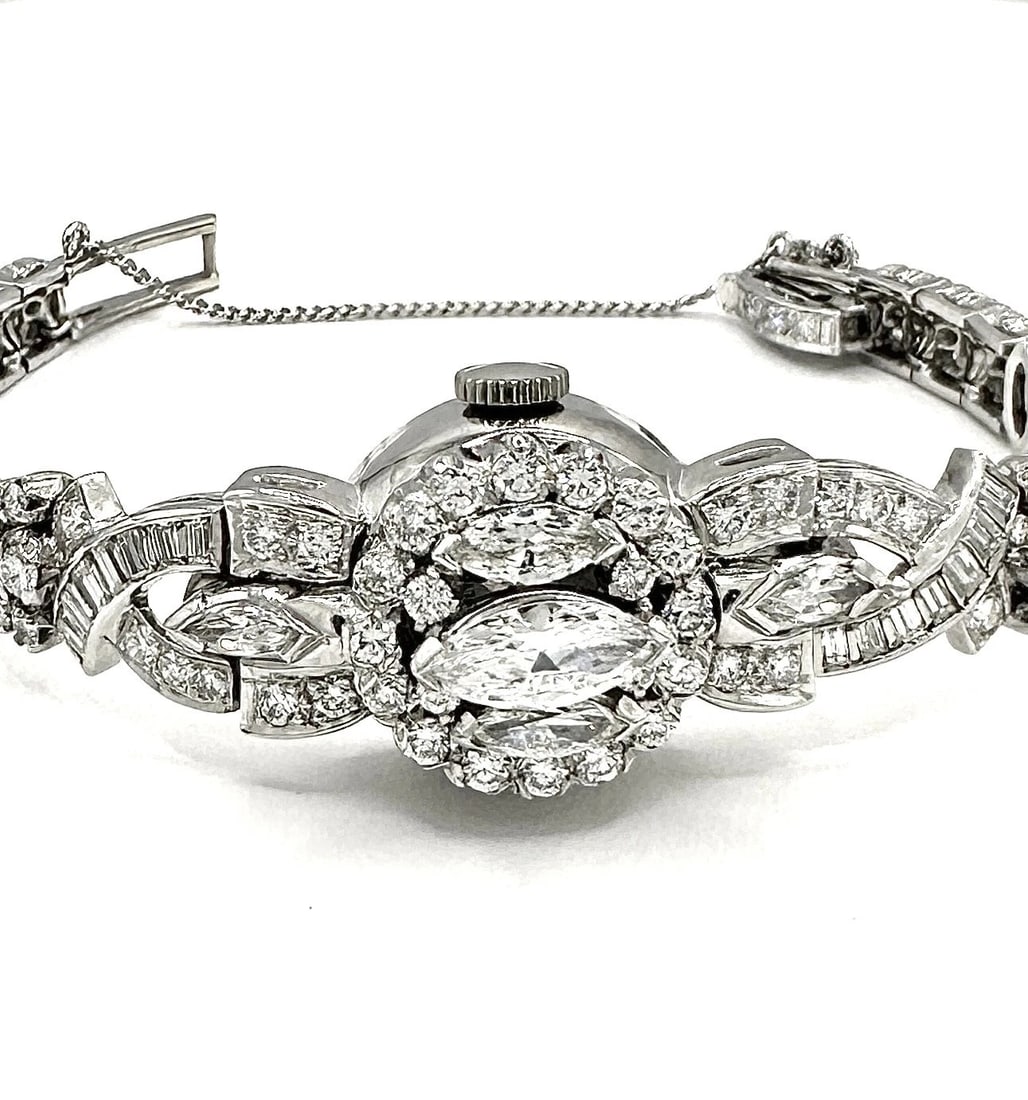 Vintage Antique 10 TCW Natural VS GH Diamond & Platinum Cocktail Watch/Bracelet: Exquisite pre-owned vintage handmade timepiece circa 1940's Crafted of solid Platinum Combination of Natural Marquise-cut, Round-cut and Baguette Diamonds (no stones missing) Clarity and Color ranges
