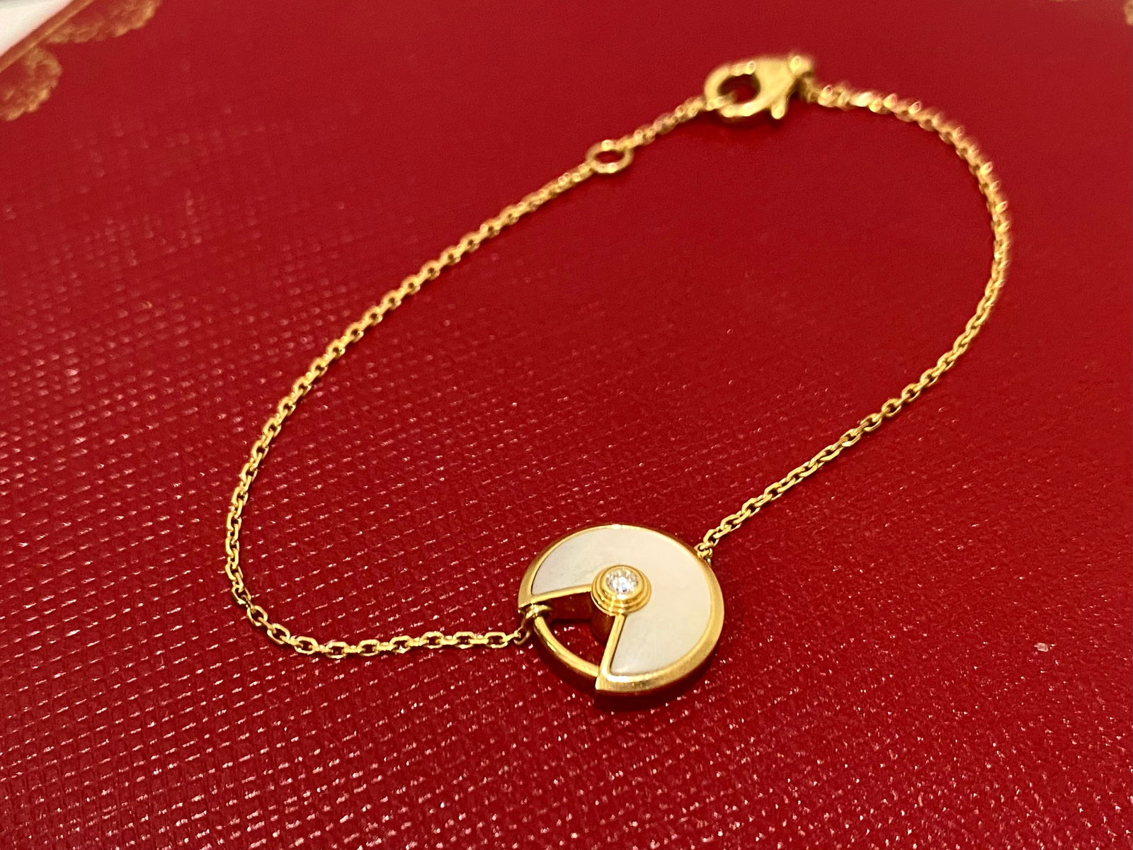 Cartier Amulette de Cartier 18K Yellow Gold Mother of Peal Diamond Bracelet XS Model: Condition: Like New Material: 18K Yellow Gold Brand: Cartier Gem Stone: Mother of Pearl and Diamond Diamonds: 0.02 ct, 2 mm diameter round-cut diamond Length: 16 cm Motif Diameter: 12 mm Weight: 2.2 g