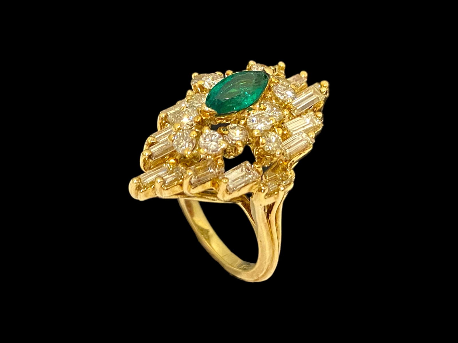 Marquise Emerald and Diamond Ring in 14k Yellow Gold: Condition: Like New Brand: Unbranded Material: 14K Yellow Gold Jewel: Diamond Stone Cut: Round brilliant-cut and Baguette-cut Diamond Count: 14 Round-cut and 16 Baguette-cut diamonds Size: 5.25 Weight