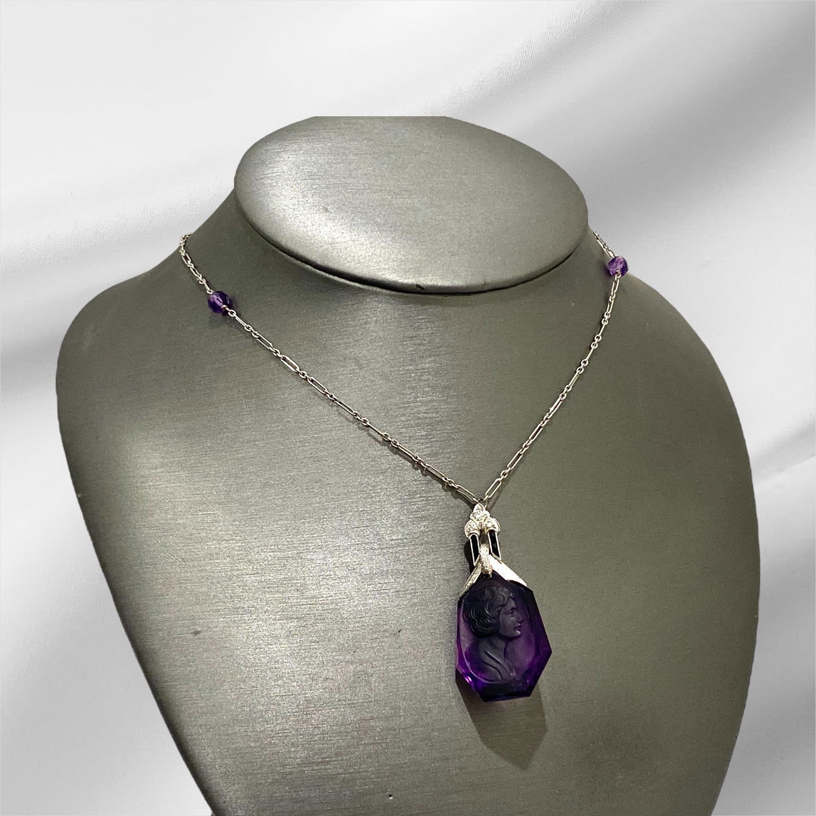 Antique Hand Carved Amethyst and Diamond Intaglio Pendant Necklace in Platinum and Gold with a: Condition: Excellent. Brand: Unbranded. Material: Platinum and 14k White Gold Gemstone: Amethyst and Black Onyx and Rose-cut Diamonds. Pendant Dimensions: Length: 46mm; Width: 23mm Necklace Dimensions