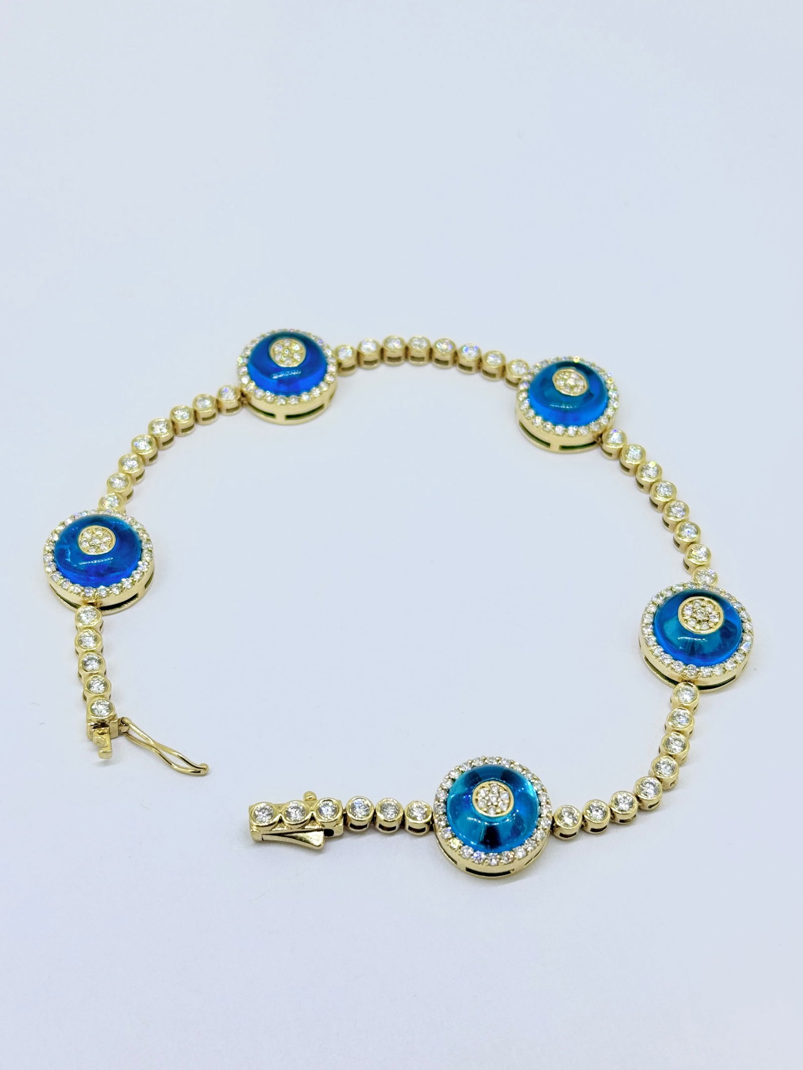 14K Yellow Gold Evil Eye Diamond Tennis Link Bracelet: Condition: Like New. Brand: Unbranded. Material: 14k Yellow Gold. Jewel: Round Diamond and Blue Sapphire. Diamond Count: 183 Round Diamonds. Total Carat Weight: Over 2 Carat. Clarity & Color: SI1-SI2;