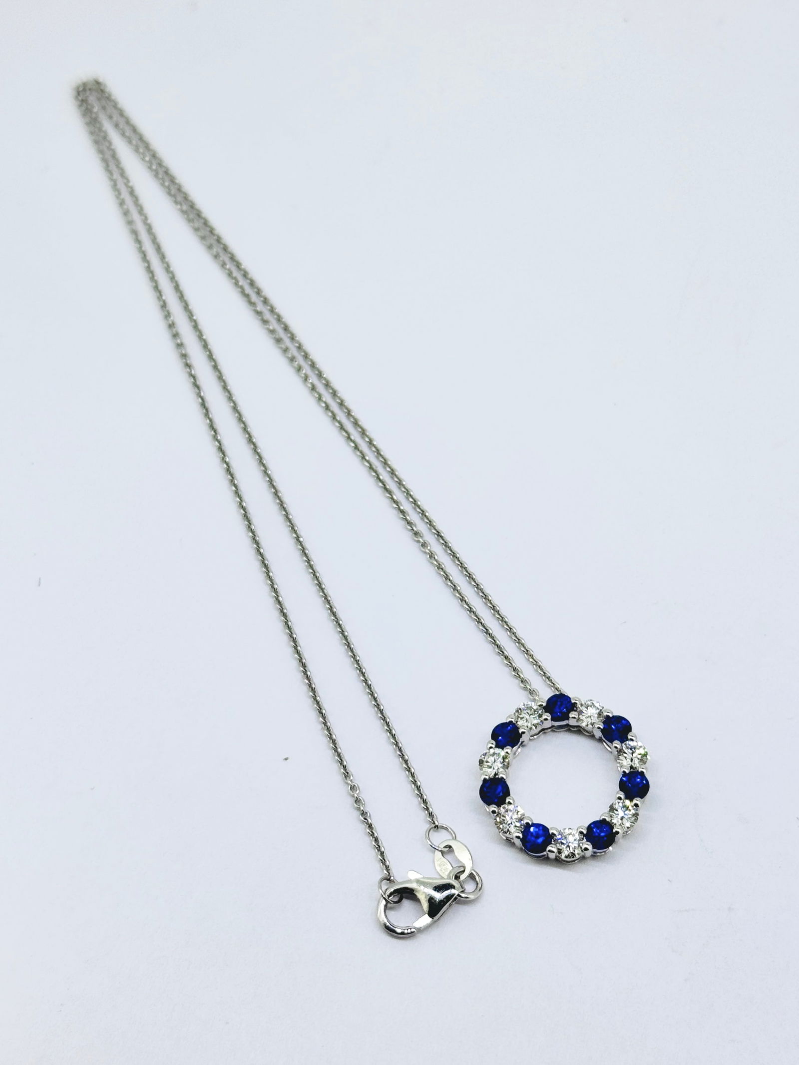 Alternating Blue Sapphire and Round Diamond Sphere Pendant Necklace in 14K White Gold: Condition: Like New. Brand: Unbranded. Material: 14k White Gold. Jewel: 7 Round Diamond and 7 Blue Sapphires. Total Carat Weight: Apx 1.5 TCW. Diamond Color & Clarity: VS1; F-G. Pendant Dimensions: 16