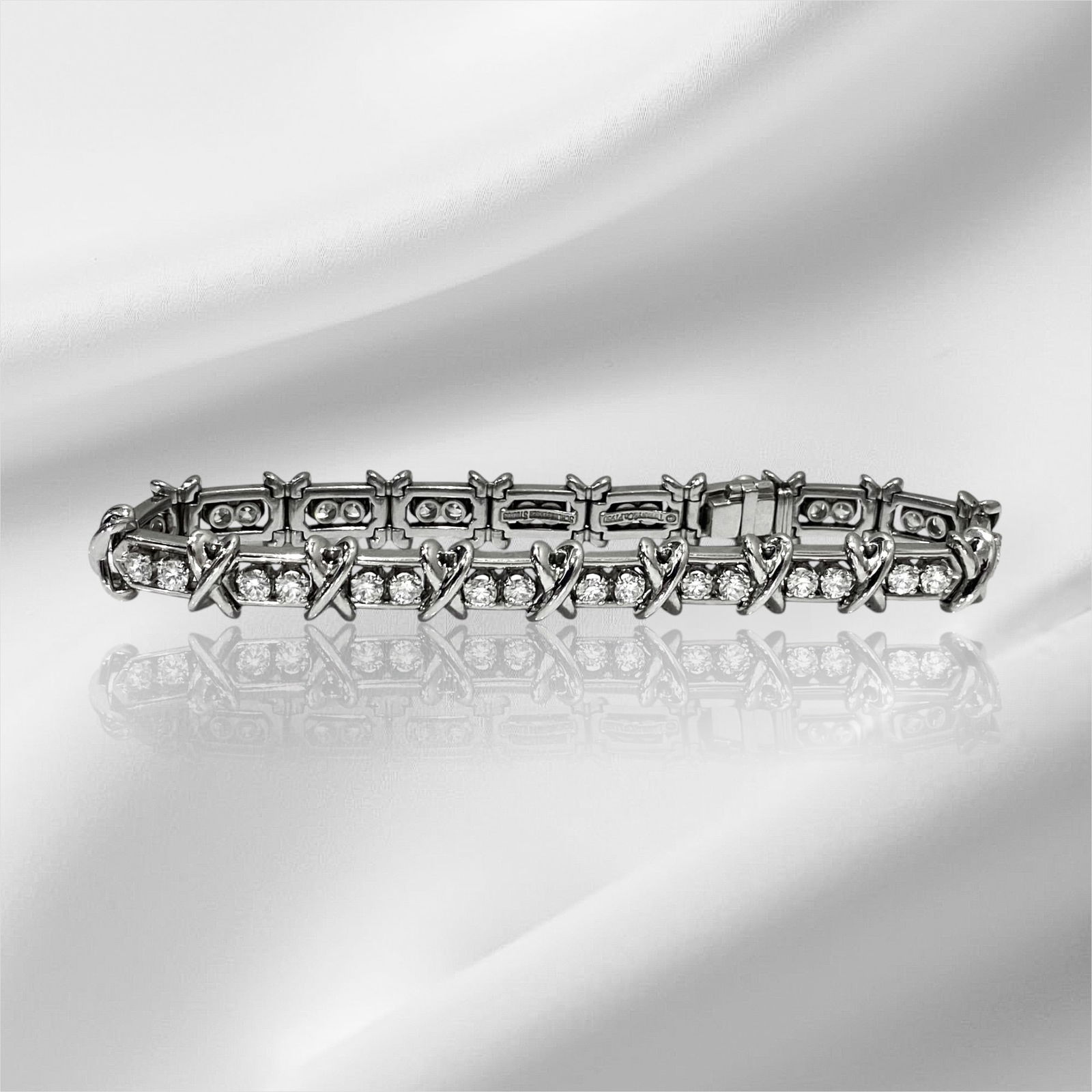 Tiffany & Co. Schlumberger Platinum Diamond 36 Stone X Tennis Bracelet: Condition: Like New Brand: Tiffany & Co. Material: Platinum PT950 Gemstone: 36 Round cut Diamond. Total carat Weight: 2.95 TCW Markings: "©Tiffany & Co." "SCHLUMBERGER STUDIOS" "PT950" Bracelet Dimen