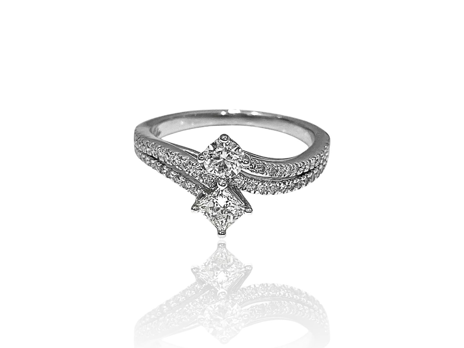 Ever Us Diamond Two-Stone Bypass Engagement Ring in 14k White Gold: Condition: Excellent. Creator: Ever Us. Metal Purity: 14k White Gold Jewel: Diamond. Stone Cut: Princess-Cut and Round-cut. Jewel Count: 58. Total Carat Weight: Over 1 Carat. Clarity & Color: SI1-SI2;