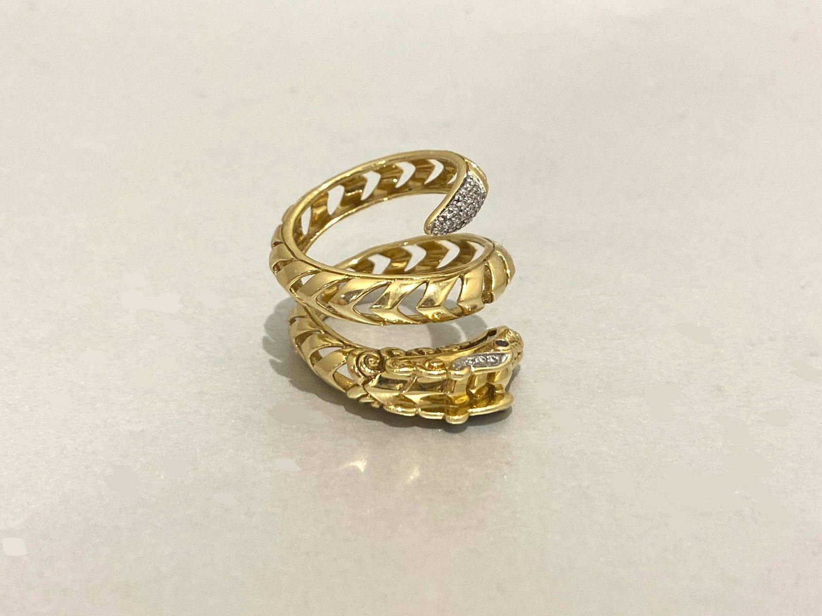 JOHN HARDY Legends Naga Dragon Wrap Around Ring in 18k Yellow Gold: Condition: Like New Brand: JOHN HARDY Material: 18K Yellow Gold Jewel: Diamond and blue sapphire Diamond Carat weight: 0.20 Carats Diamond Count: 30 Stone Cut: Round Size: 5.5 - 6 Weight: 12 grams
