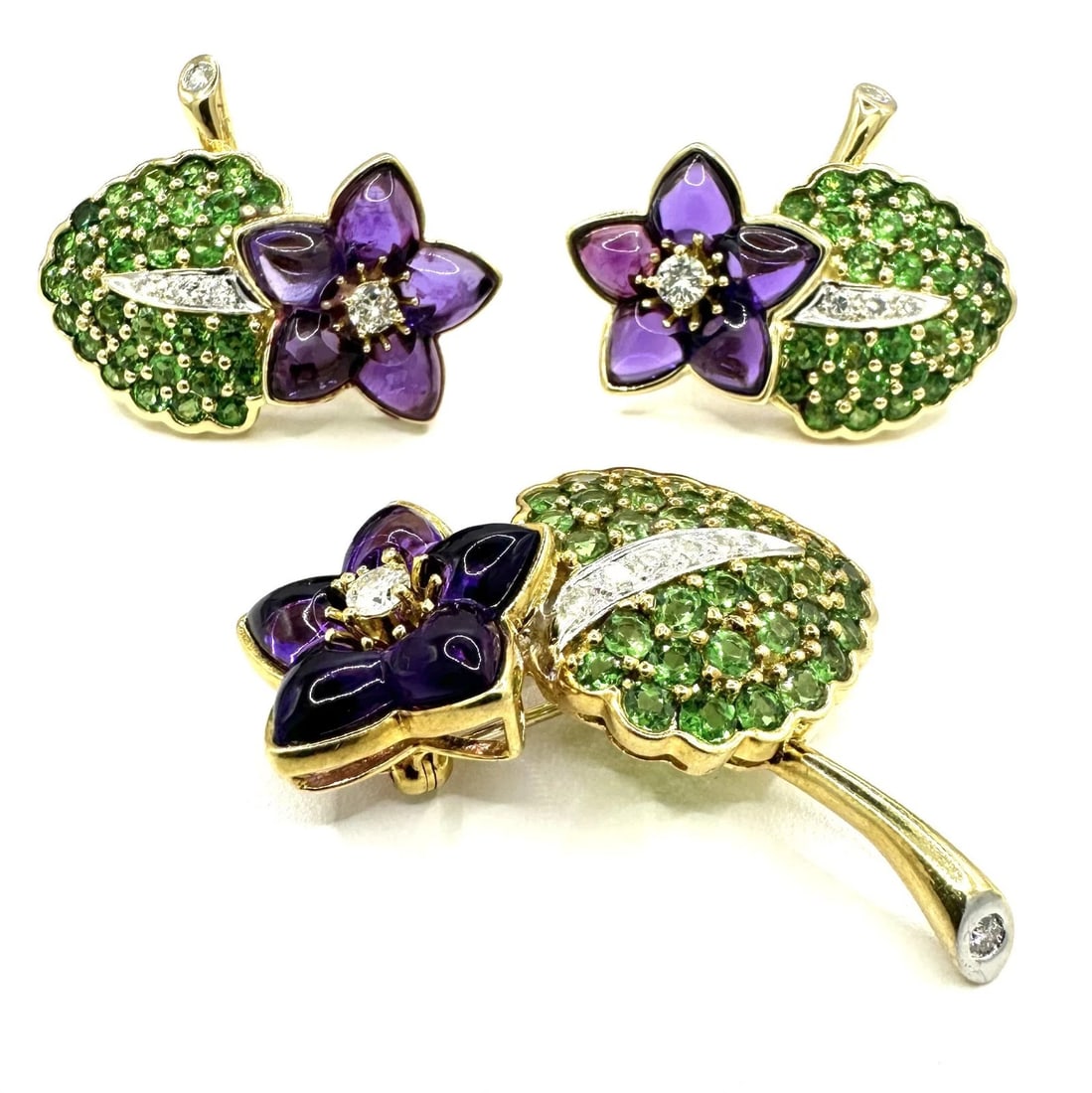 TIFFANY & Co. 18K Gold Multistone Diamond/Amethyst/Peridot Set Earrings & Brooch: Brand/ Maker: Tiffany & Co. Item: Brooch and Pair of Earrings with post and clip on as well. Total weight of the set: 46.6 grams Condition: Excellent, Gently pre owned, (One of the amethyst flower pet