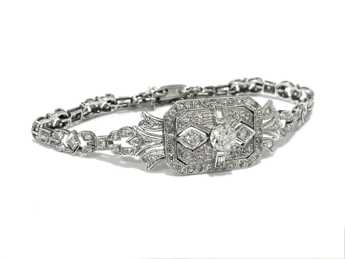 APX 4.2 TCW Diamond Vintage Art Deco Platinum and Diamond Bracelet, Circa 1920's: Item: Bracelet Metal: Platinum Gemstone: Diamonds Total Diamond Count: 114 Round Brilliant cut And 18 Baguette cut Diamonds Diamond Carat weight: Center: 0.80Carat and Total: APX 4.2 TCW Clarity: VS1-