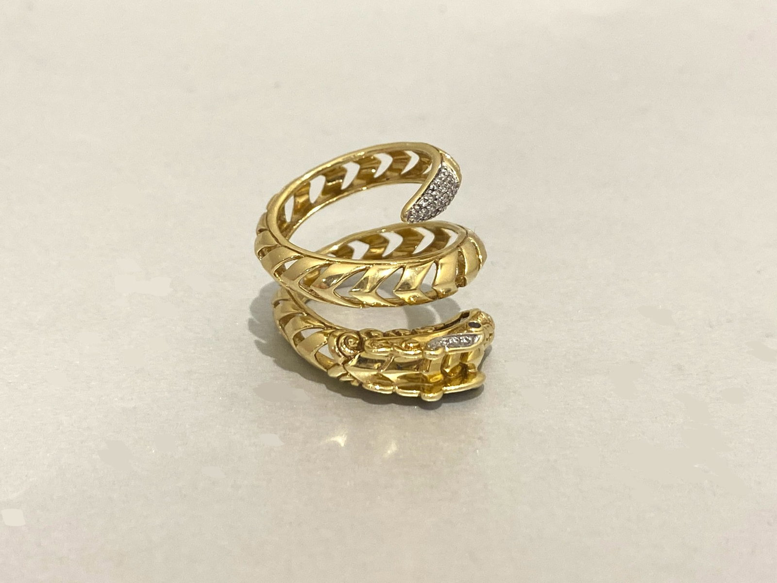 JOHN HARDY Legends Naga Dragon Wrap Around Ring in 18k Yellow Gold: Condition: Like New Brand: JOHN HARDY Material: 18K Yellow Gold Jewel: Diamond and blue sapphire Diamond Carat weight: 0.20 Carats Diamond Count: 30 Stone Cut: Round Size: 5.5 - 6 Weight: 12 grams