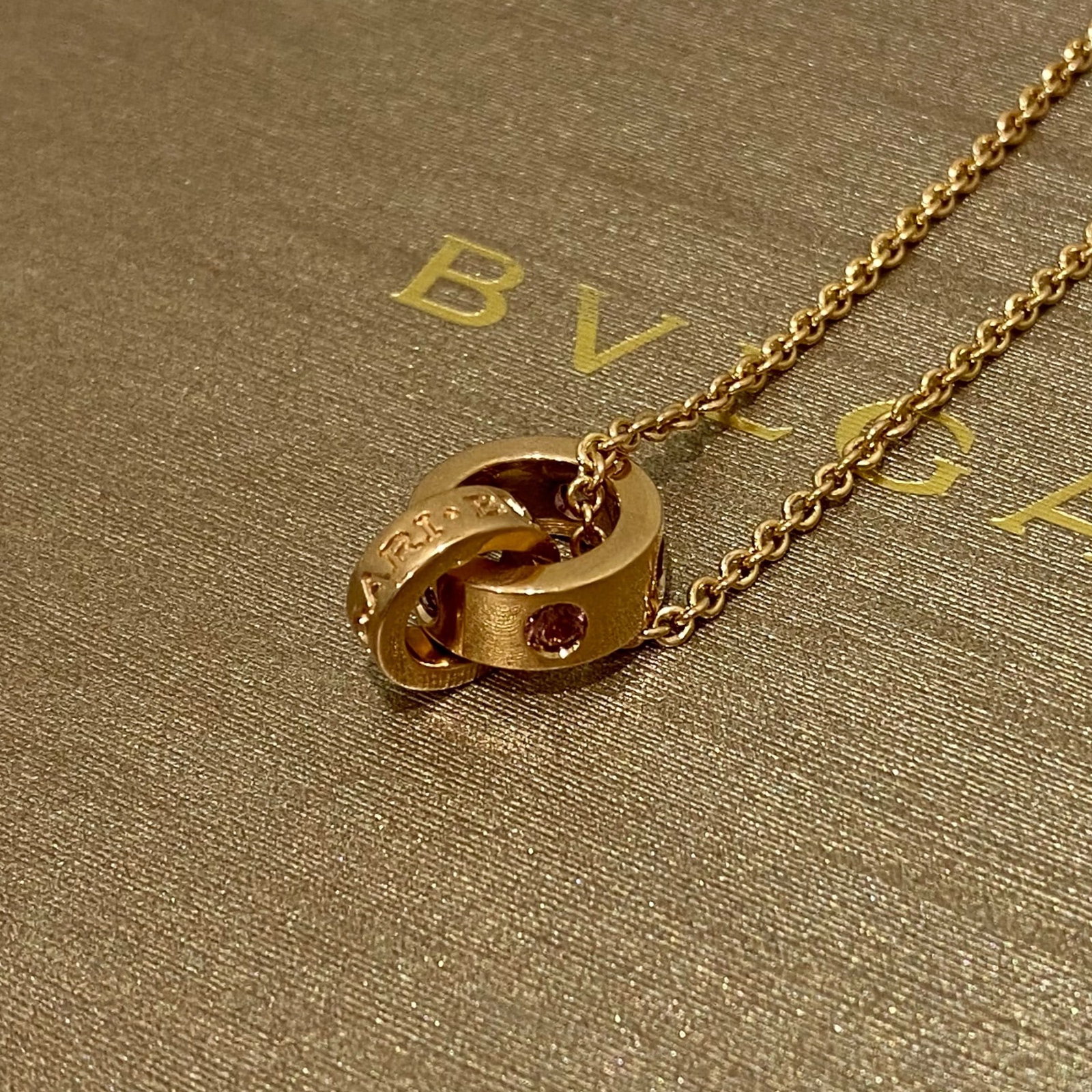 BVLGARI Pink Sapphire Link Pendant Necklace in 18K Rose Gold: Condition: Like New Designer: BVLGARI Material: 18K Rose Gold Jewel: Pink Sapphire Pink Sapphire Count: 5. Necklace Dimensions: 16 inches (adjustable) Weight: 12 grams.
