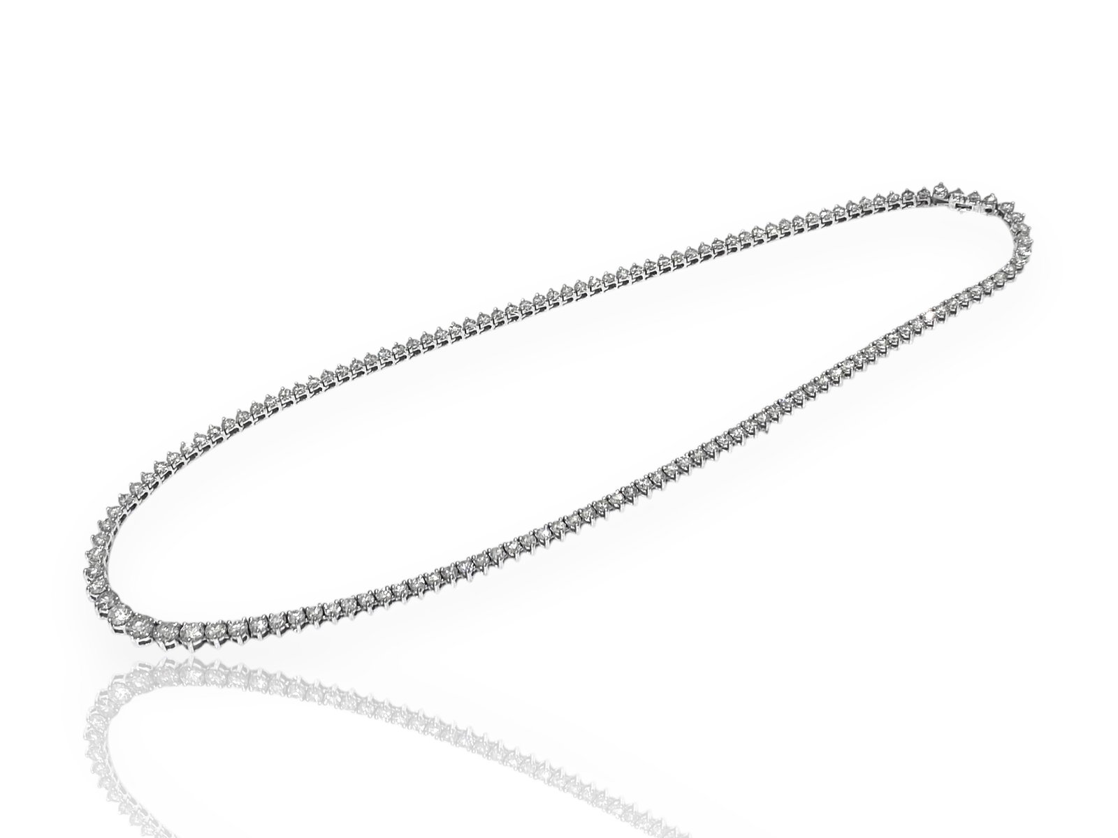Over 10 Carat Diamond 3-Prong Graduated Tennis Necklace in 14k White Gold.: Condition: Like New. Brand: Unbranded Metal: 14k White Gold. Gemstone: Round Brilliant-cut Diamond. Diamond Count: 137. Carat Weight: Over 10 Carat Color & Clarity Grade: SI1; F-G Necklace Length: 16"