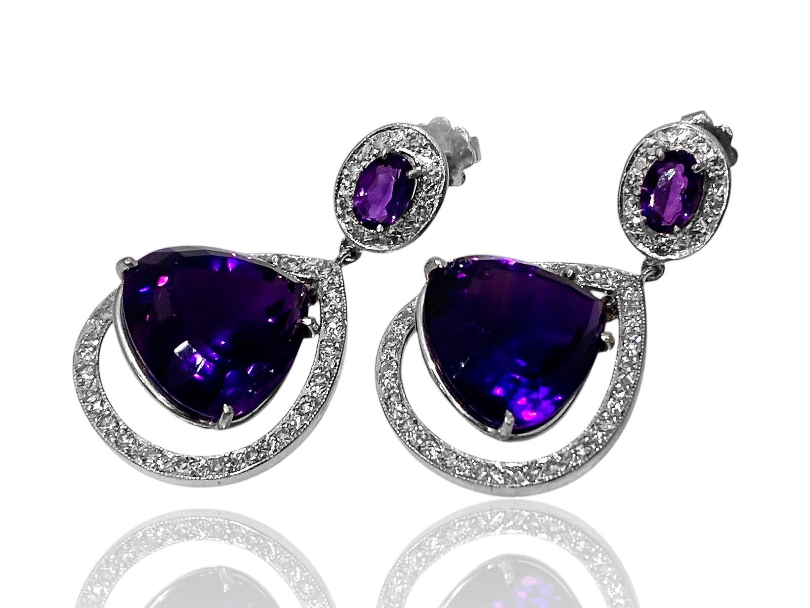 Radiant Amethyst and Halo Diamond Drop Stud Earrings in 14k White Gold: Condition: Like New Brand: Unbranded. Metal: 14K White Gold. Center Stone: Amethyst and Round Diamond. Amethyst Dimensions: 18mm x 18mm. Diamond Count: 64 Stones. Earrings Dimensions: 1.3" x 0.8" Weig