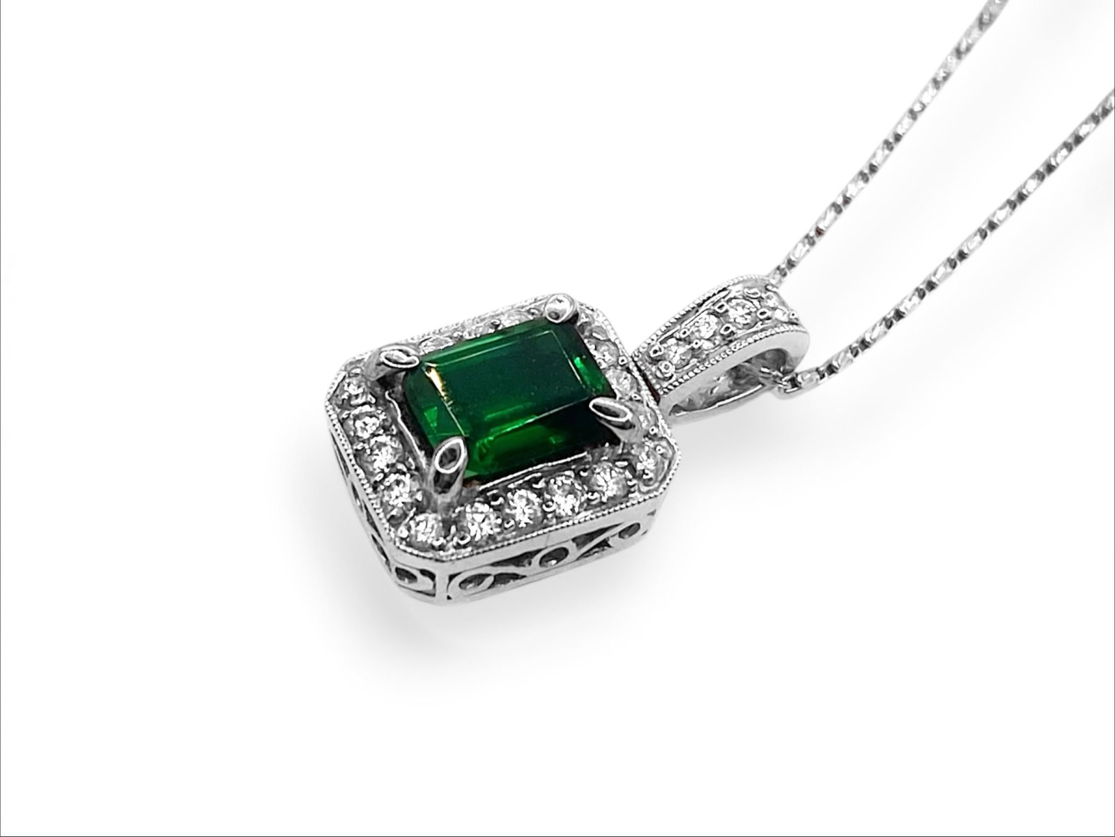 Emerald-cut Green Spinel and Diamond Halo Pendant Necklace: Item: Necklace. Brand: Unbranded. Metal: 18k White Gold Pendant and 14K White Gold Necklace. Total weight: 6.8 grams. Gemstones: Green Spinel and Diamonds. Green Spinel Dimensions: Length: 8.50mm; Wid