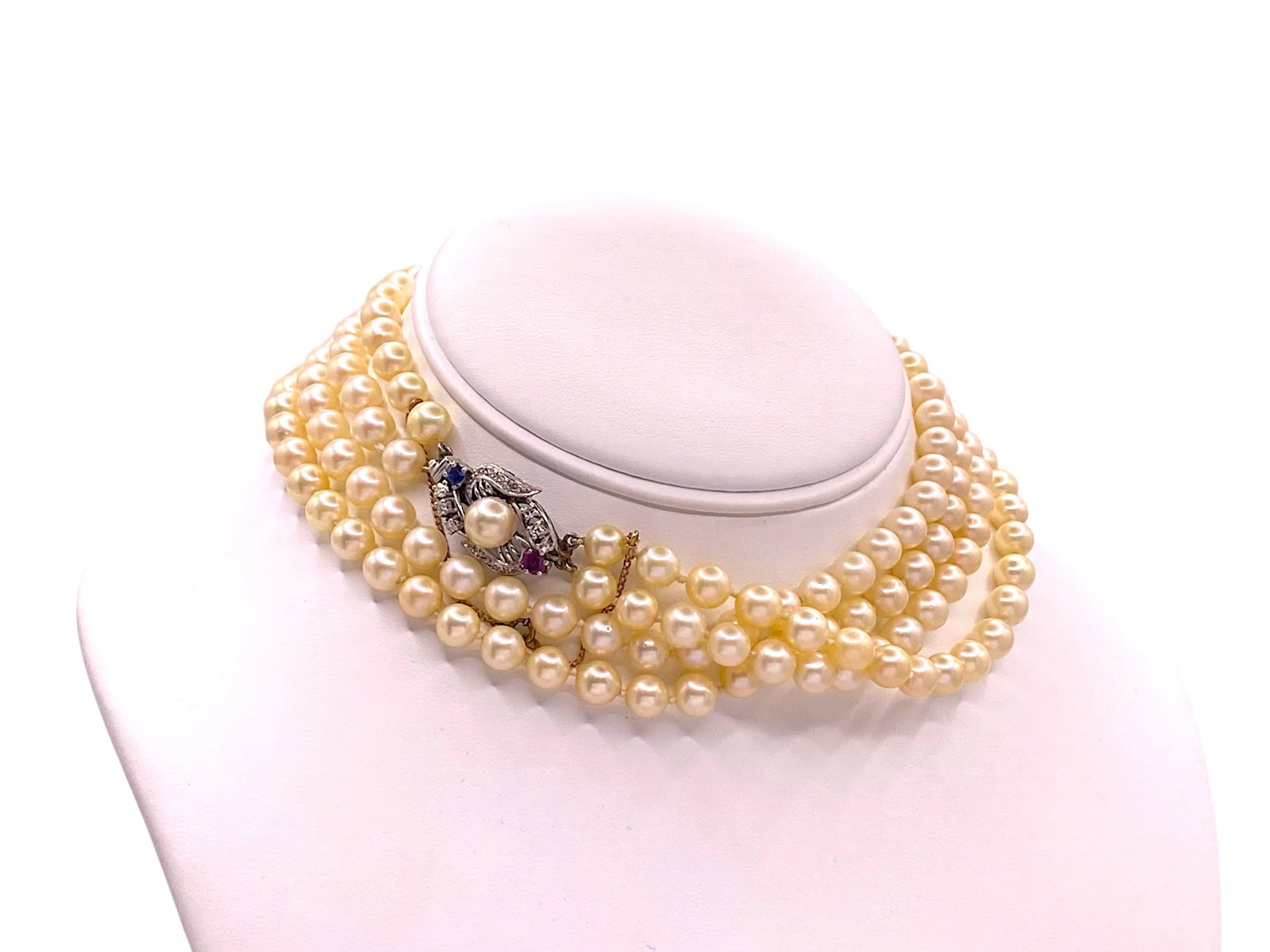 Estate Double-Strand Cultured Pearl Necklace With Ruby And Diamond Clasp: Item: Pearl Necklace. Brand: Unbranded. Metal: 14K White Gold. Total weight: 83.5 grams. Necklace Dimensions: Length: 24" inches. Gemstones: Pearls, Diamonds, Ruby and Blue Sapphire. Pearls: 170 Cultu