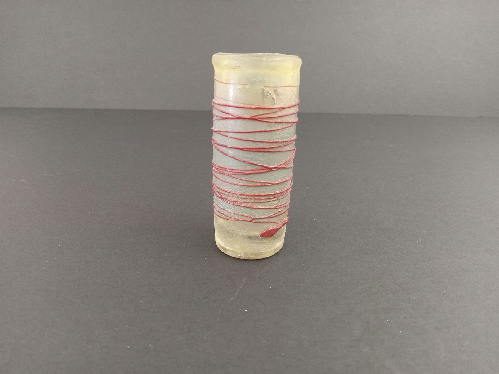 Berti Vallen Boda Glass Vase: Bertil Vallien art glass vase for Kosta Boda, featuring a clear glass body with applied red glass spun spiral swirl. About 5 inches tall.