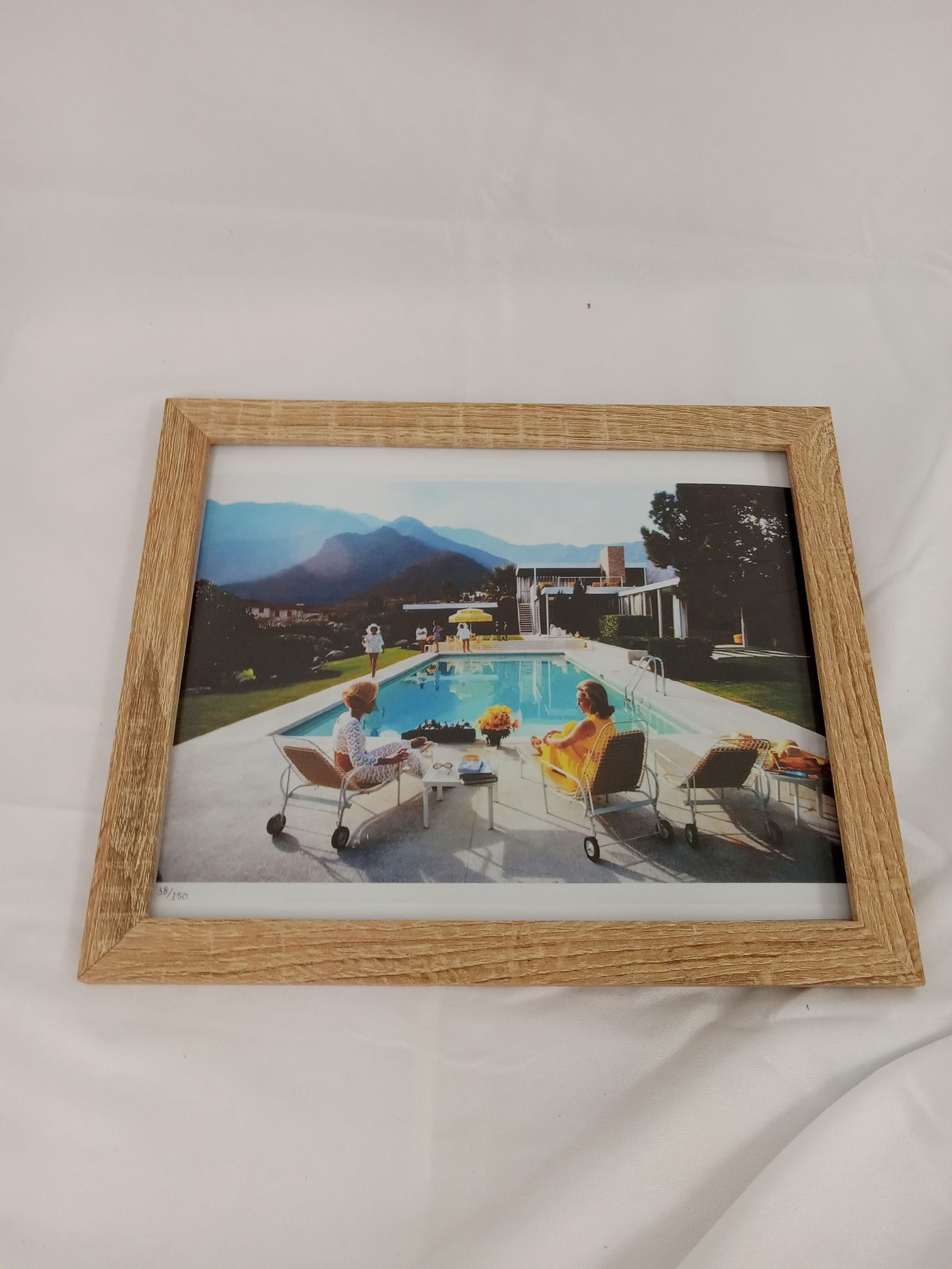 Slim Aarons "Poolsside Gossip, 1977" Framed: Slim Aarons "Poolsside Gossip, 1977" on high gloss Kodak photo paper. Image measures 8x10 inches. Framed