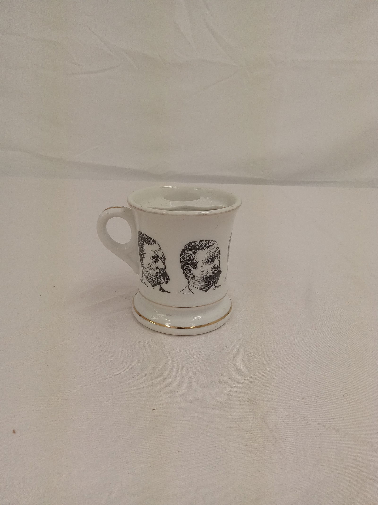 Antique tea cup with faces: Antique tea cup with faces
