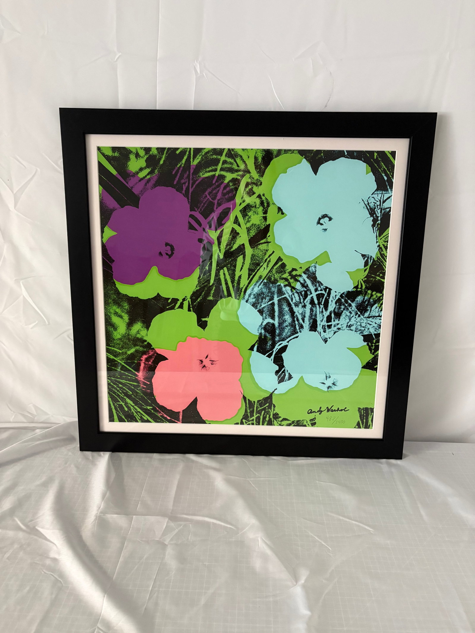 Andy Warhols "Flowers" Print After: after Andy Warhols "Flowers", Print on heavy wove paper. Print is pencil signed in bottom right corner. Framed, measures 24x24 inches. Selling as After Warhol, these are part of the estate sale and we