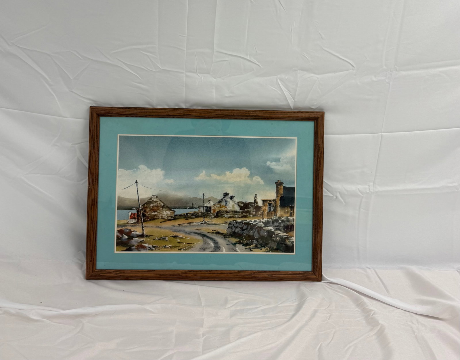 Framed Watercolor of Coastal Landscape: Unknown Artist. Watercolor painting of a coastal landscape. Measures 12x18inches.These are part of the estate sale and we do not have a COA. All lots offered in our auctions are sold strictly on an "A