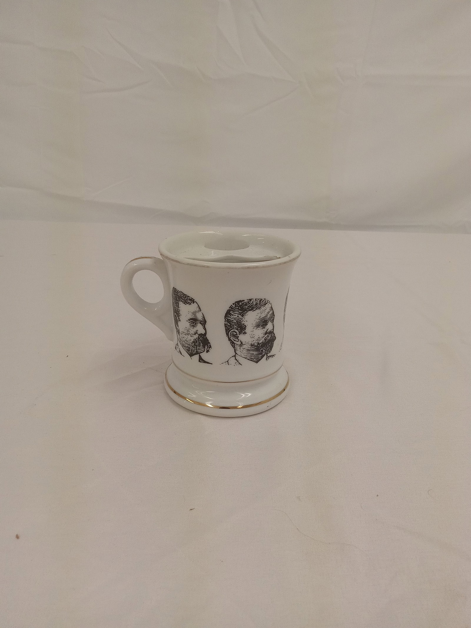 Antique tea cup with faces: Antique tea cup with faces These are part of the estate sale and we do not have a COA. All lots offered in our auctions are sold strictly on an "AS IS" basis. Any descriptions regarding an item’s