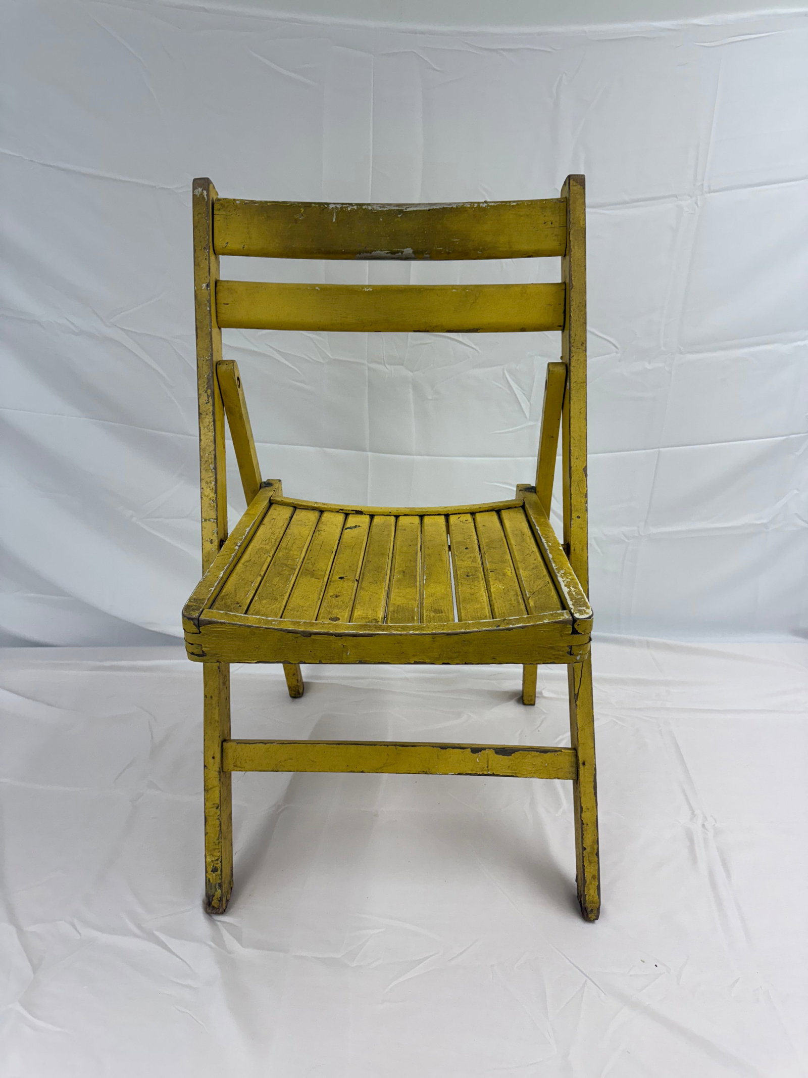 Antique Vintage Yellow Folding Chair: Vintage folding chair. Measures H32"xW21"xL16" unfolded. H32"xW4"xL16" folded. These are part of the estate sale and we do not have a COA. All lots offered in our auctions are sold strictly on an "AS 
