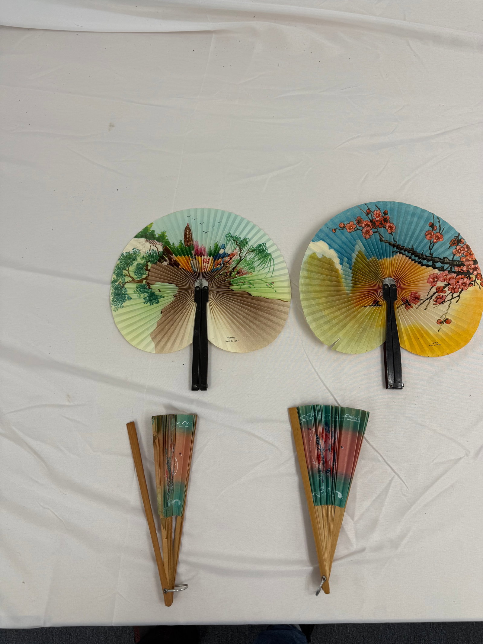 Set of 4 Vintage Folding Hand Fans: 4 folding hand fans of various sizes and decoration. These are part of the estate sale and we do not have a COA. All lots offered in our auctions are sold strictly on an "AS IS" basis. Any description